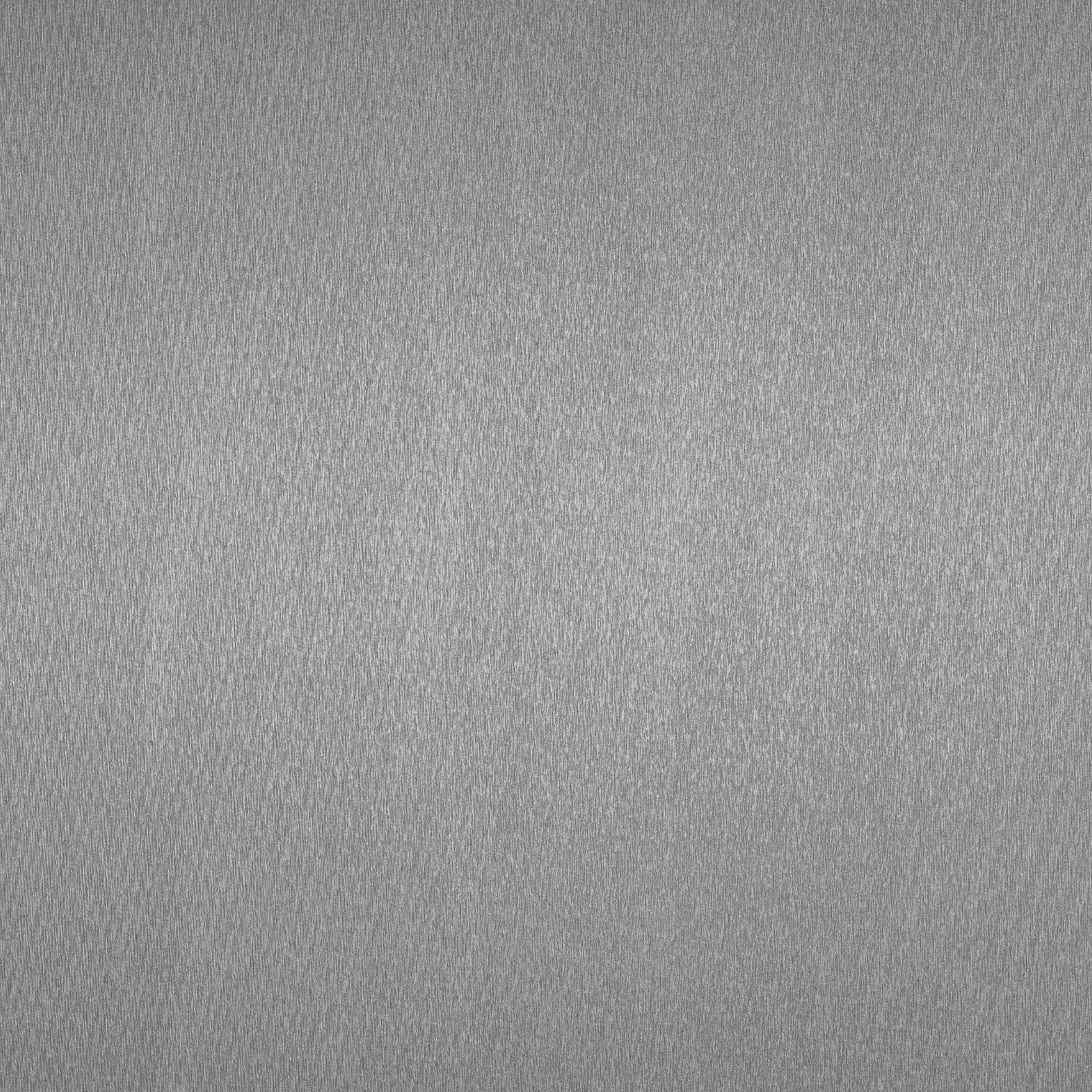 A close-up of a metallic surface with a textured, grainy appearance.