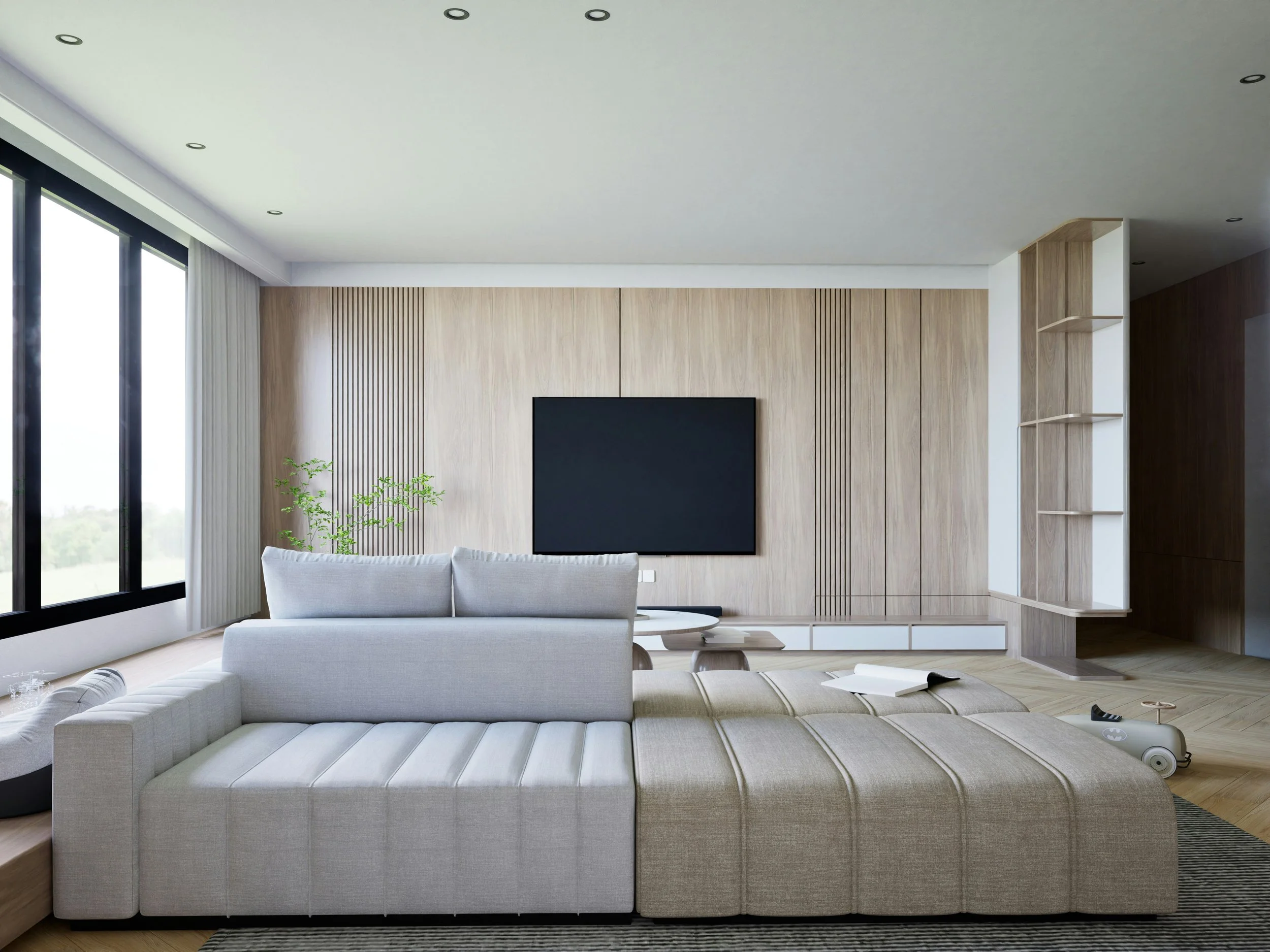 Modern living room with large windows, light wood paneling, a flat-screen TV, a gray sectional sofa, an open book, and a children's ride-on toy.