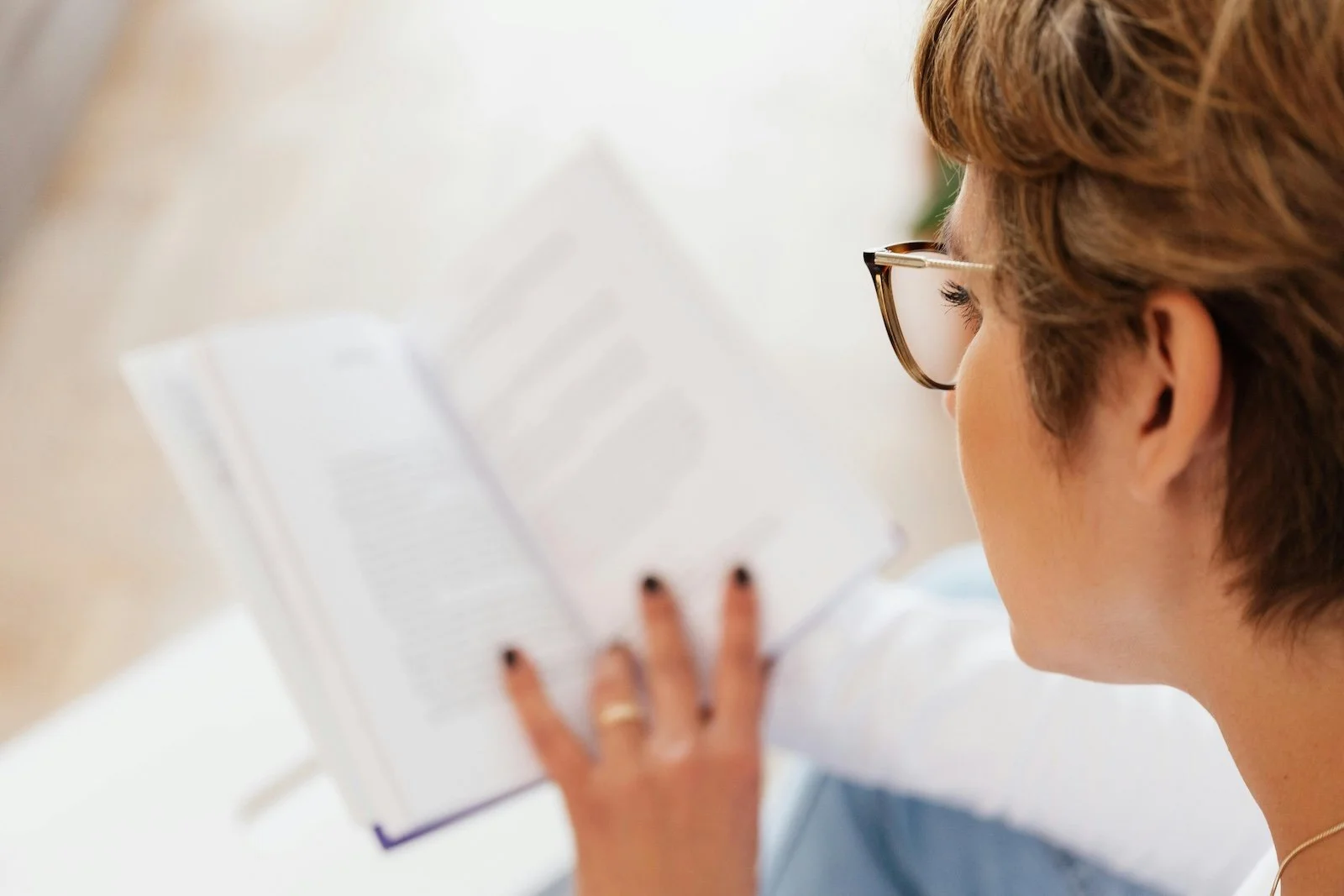 Woman reading a book  and learning about perimenopause