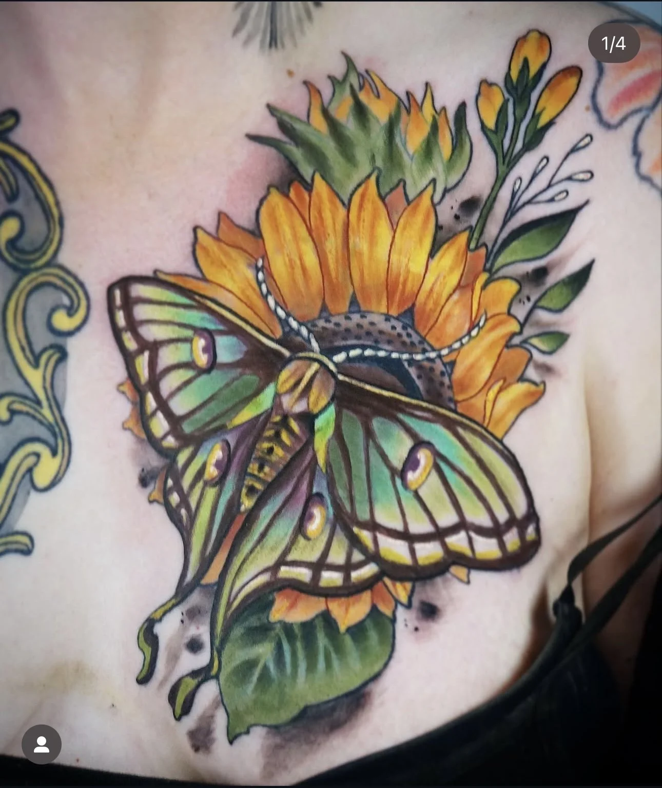 Colorful tattoo of a butterfly on a sunflower with leaves, on a person's chest.