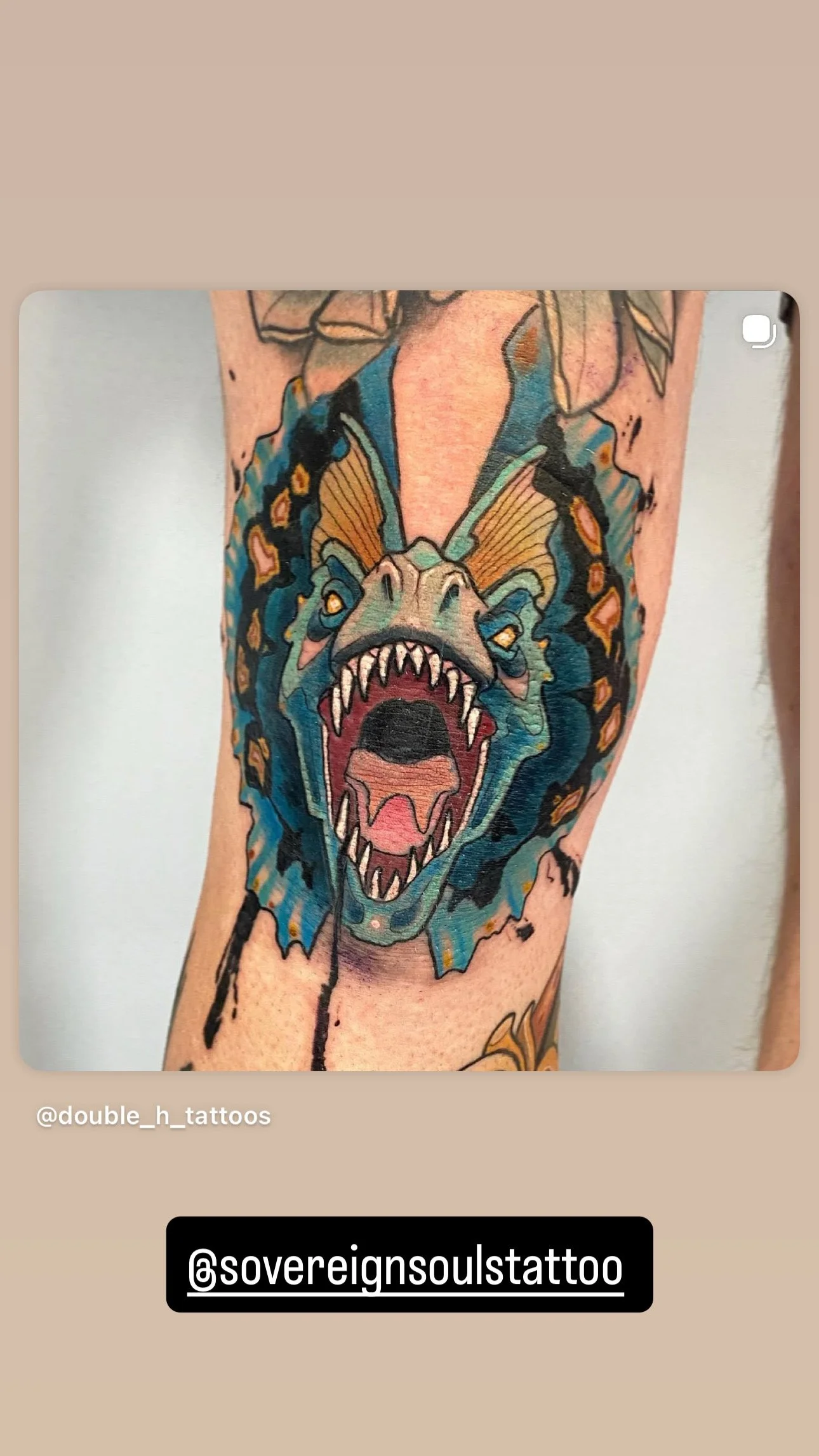 Colorful tattoo of a roaring dinosaur with wings, open mouth, sharp teeth, and detailed face, on person's arm.