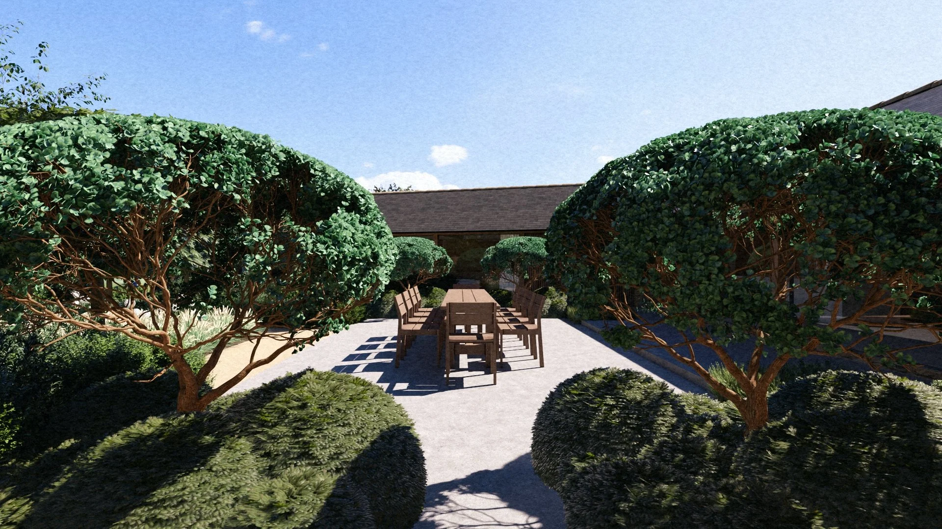 A backyard garden with trimmed bushes and trees, a stone pathway, a wooden dining table with chairs, and a clear blue sky.