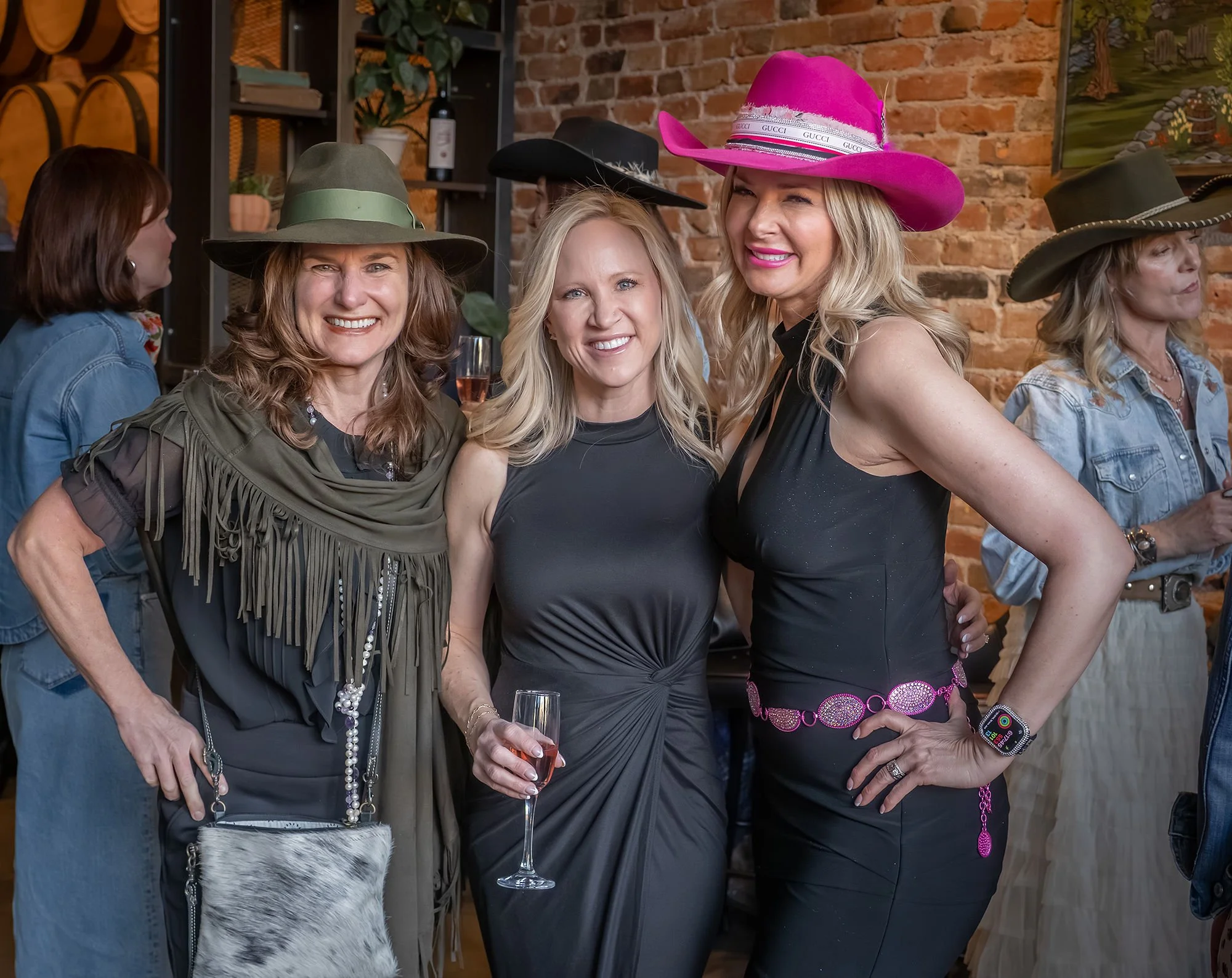 Guests engaging in a hands-on hat customization experience designed for elite weddings and VIP events.