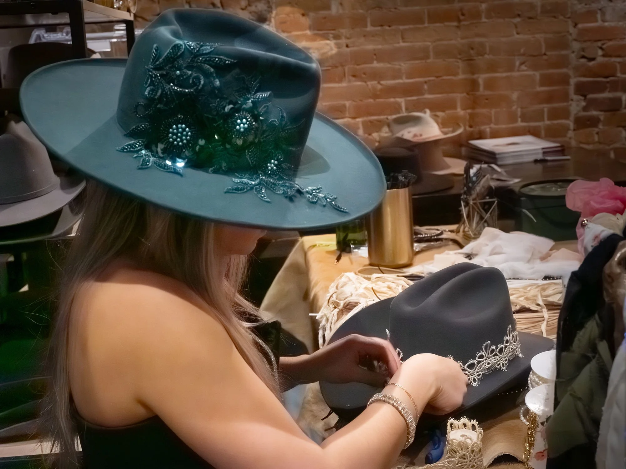 Detailed shot of hand-branded hat designs created at a luxury hat bar activation for corporate and social events.