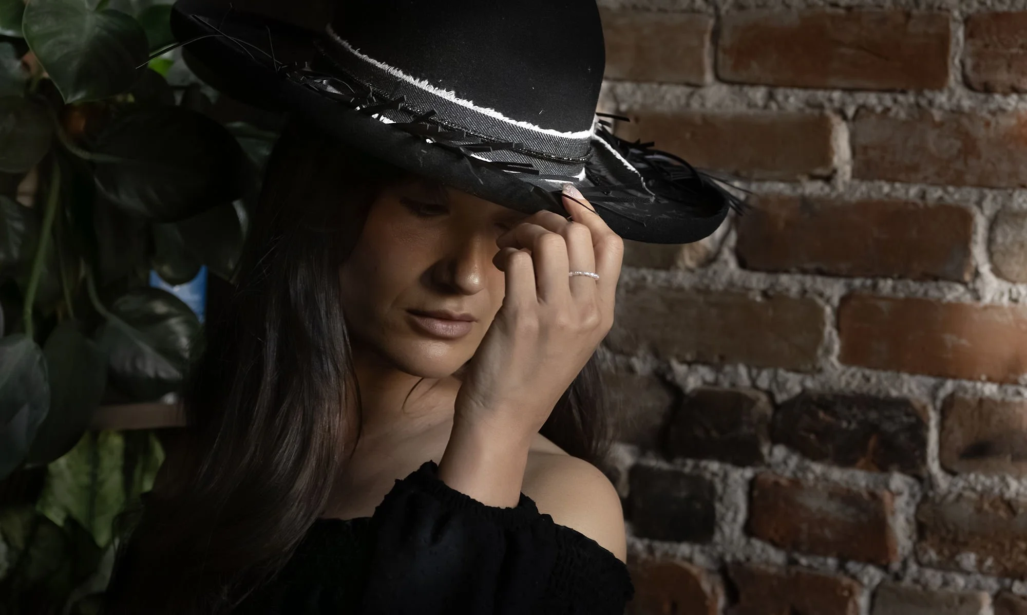 Close-up of layered hat details including branding, accessories, and textures for an editorial Western fashion look.