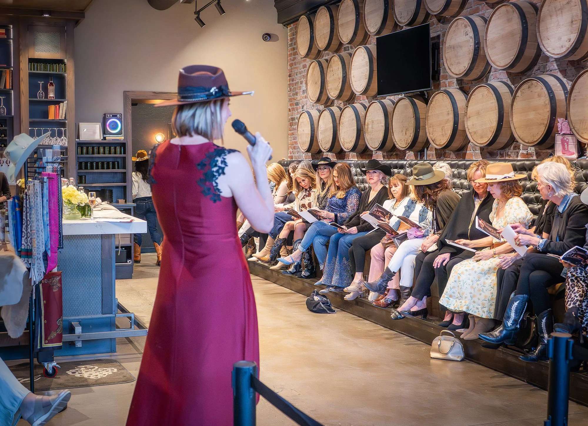 Guests enjoying a wine tasting while creating custom hats at a vineyard-inspired luxury event experience.