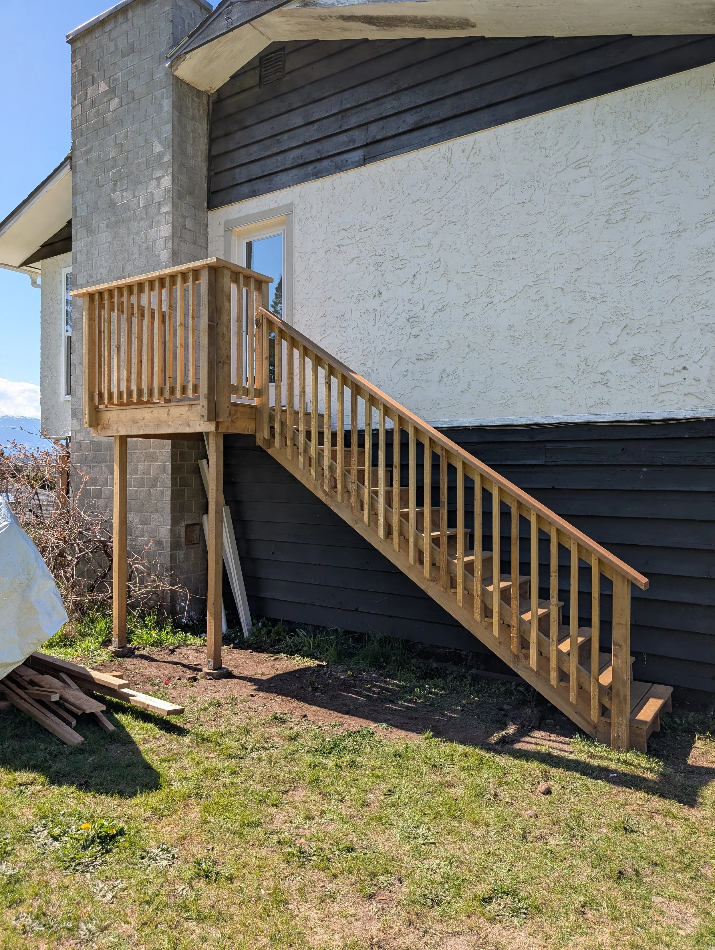 Exterior door, small deck and stairs addition to provide 2nd floor backyard access for Courtenay renovation.