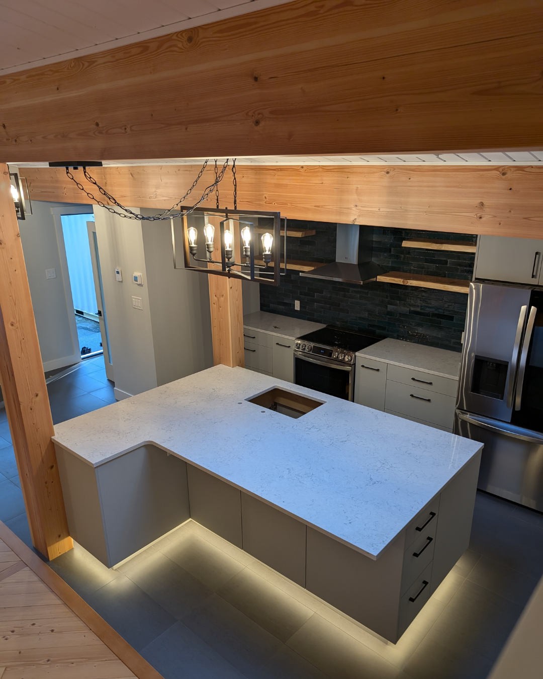 The client wanted a larger island than what was already there because she is a chef and wants more space to prep.