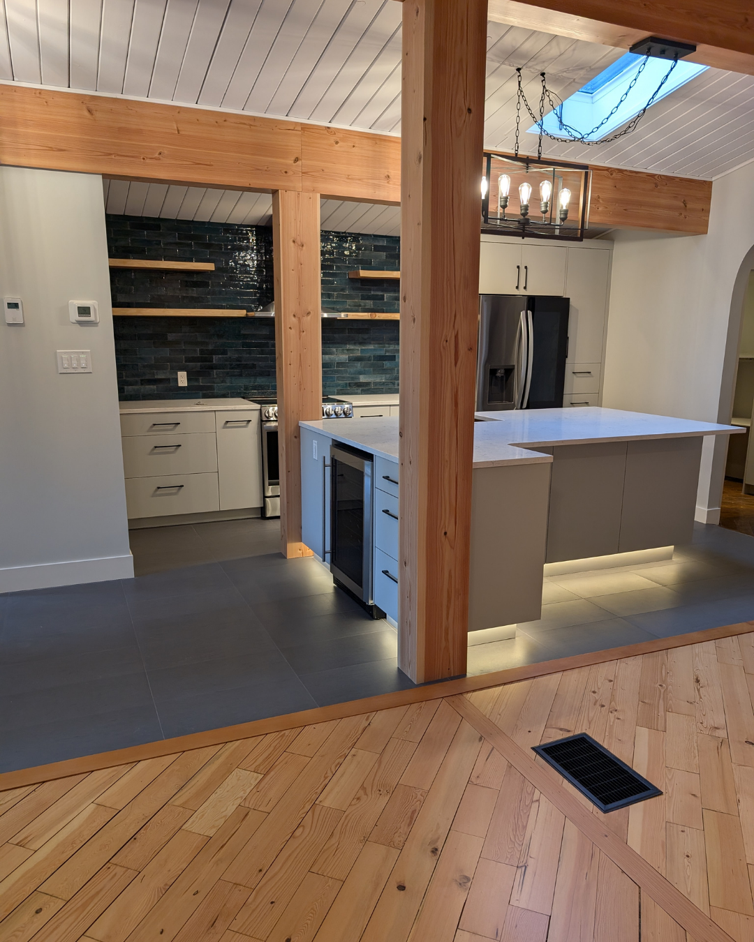 Renovated kitchen with a island and timber wrapped posts.