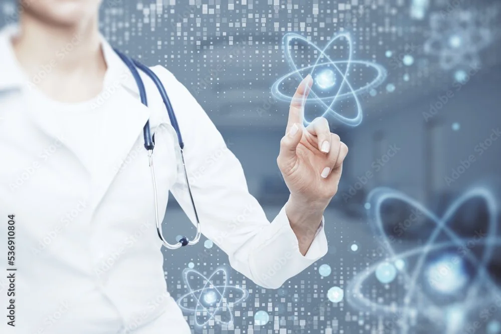 A healthcare professional in a white coat and stethoscope touching a digital atom symbol projected in the air.