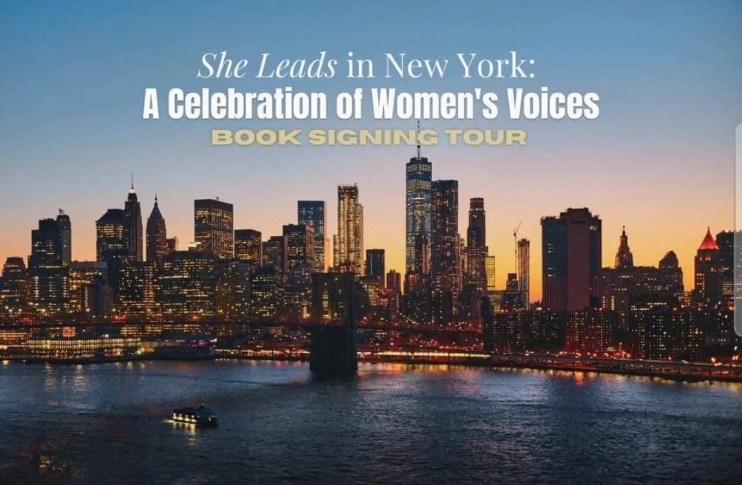 Digital poster of a book signing tour titled 'She Leads in New York: A Celebration of Women's Voices,' featuring a cityscape of New York City at sunset with tall buildings, a river in the foreground, and a boat on the water.