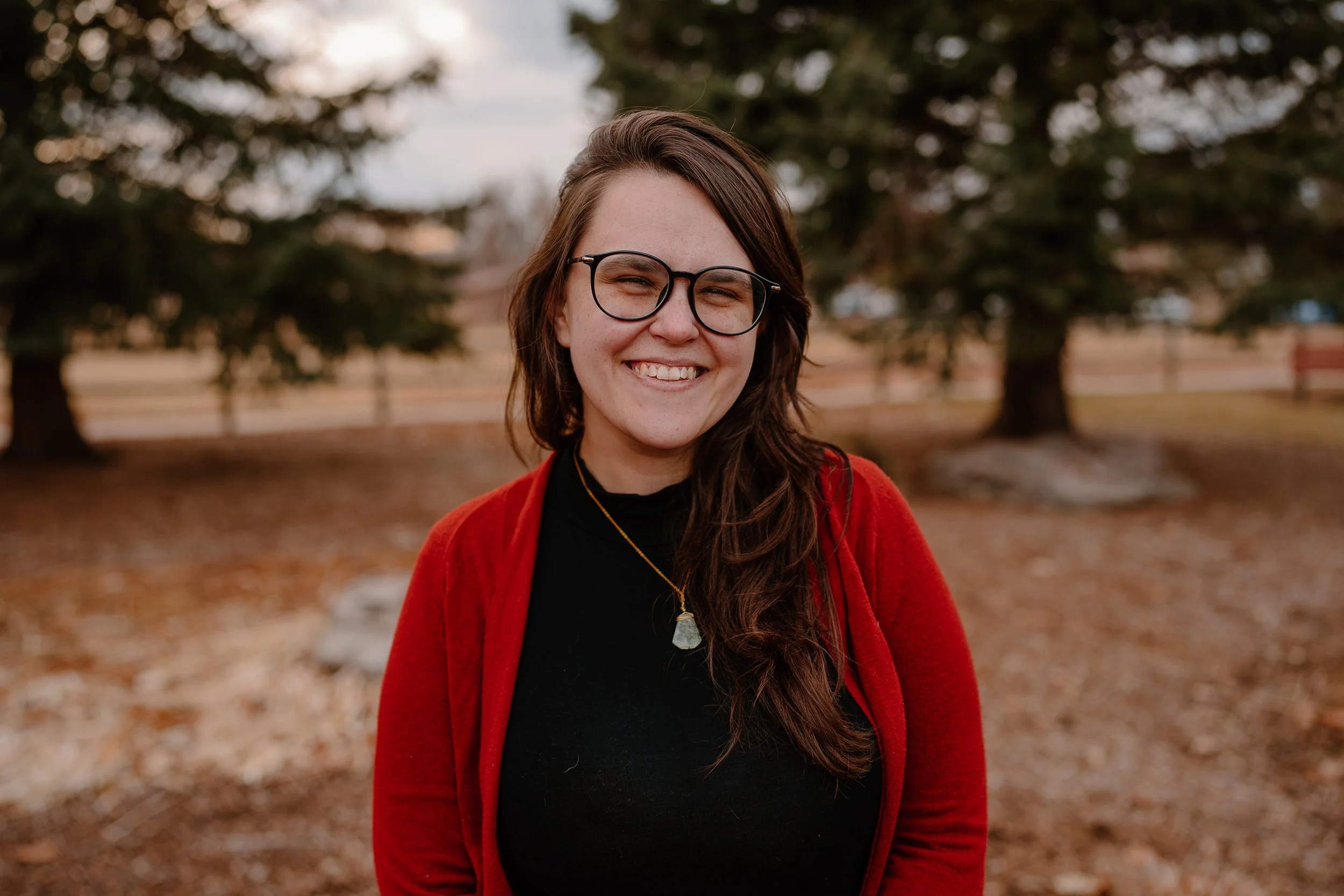 Melissa, a white woman with brown hair and glasses, smiles at the camera.