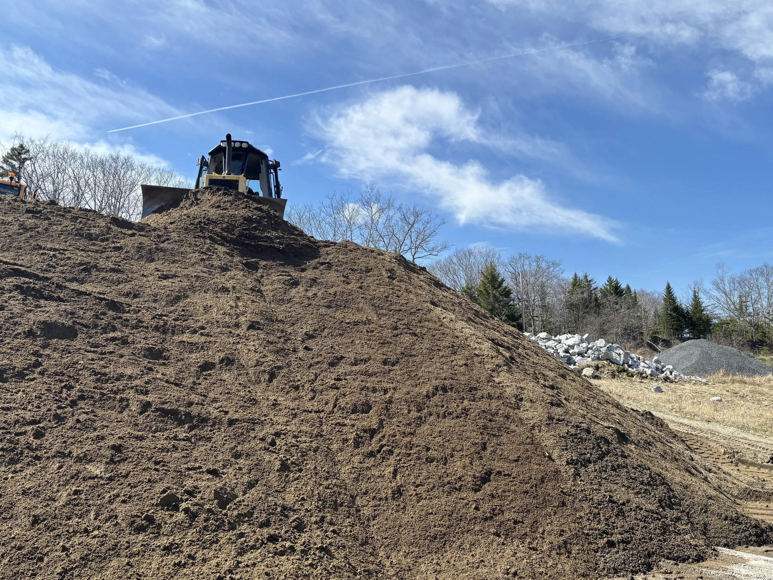Billy Hutchins pushes dirt over the side.