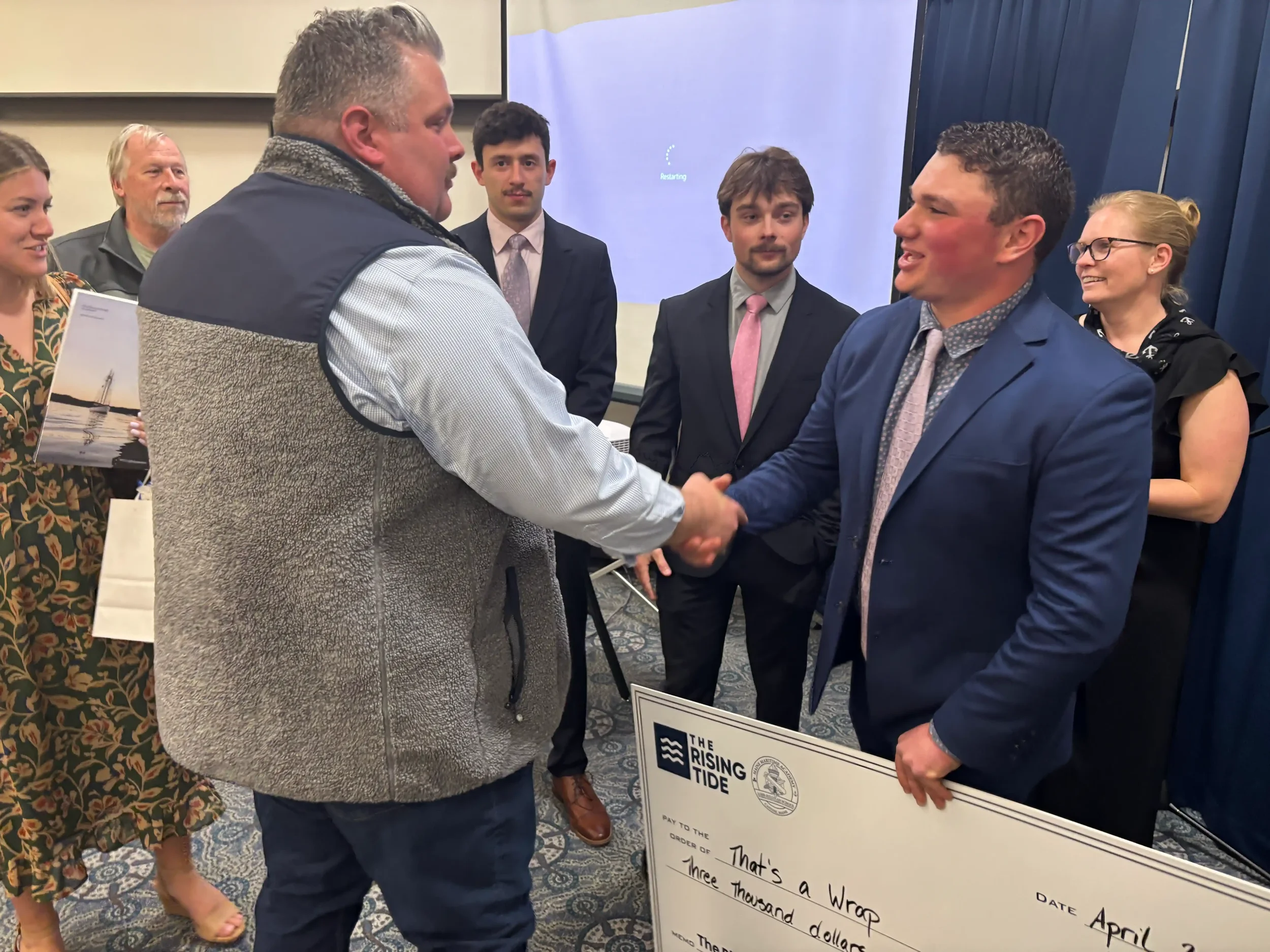 Oscar Adams of Deloitte congratulates Spencer Bigman on his win.