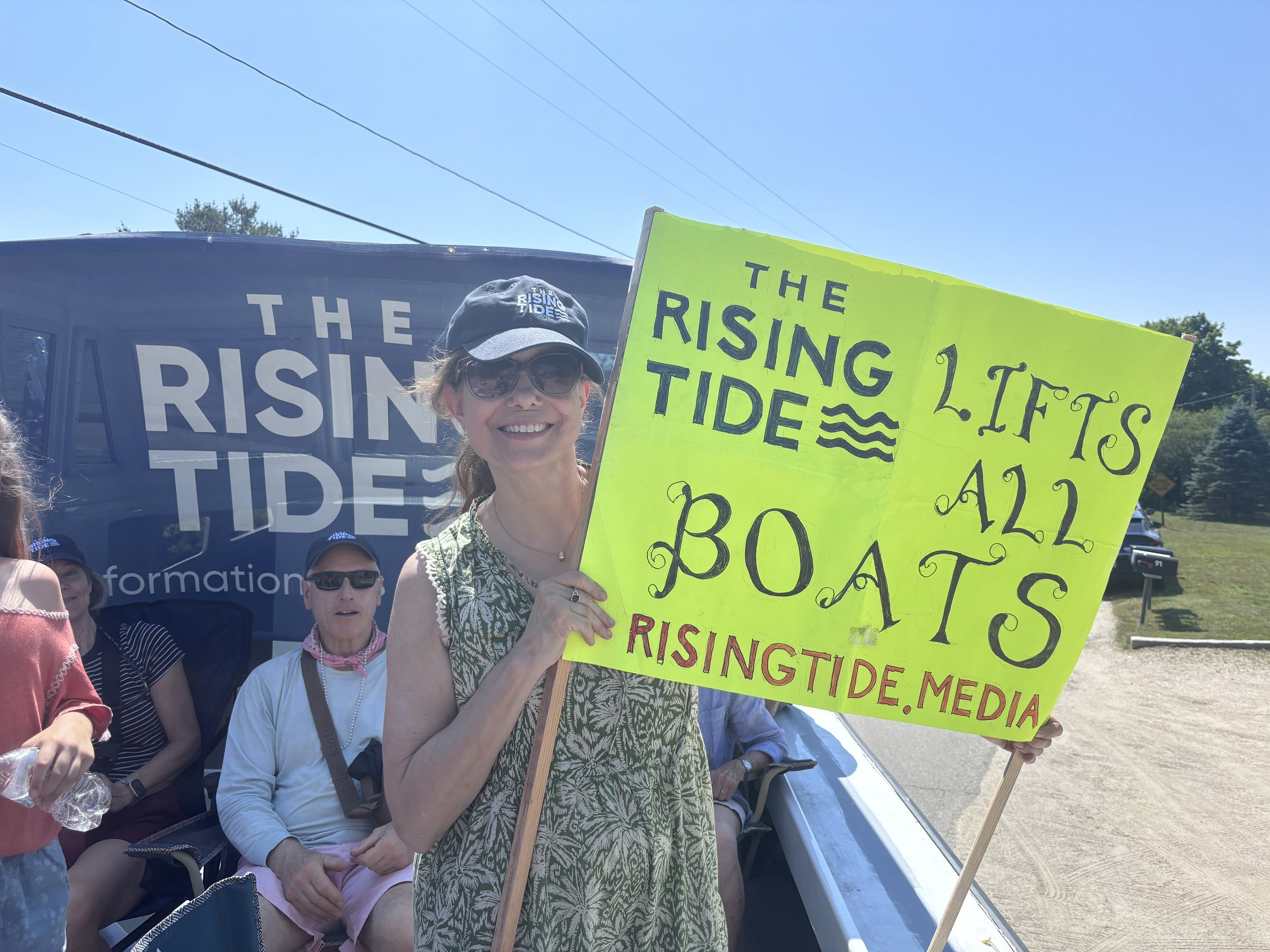 Lucia Case of Penobscot holds up her sign on board the float.