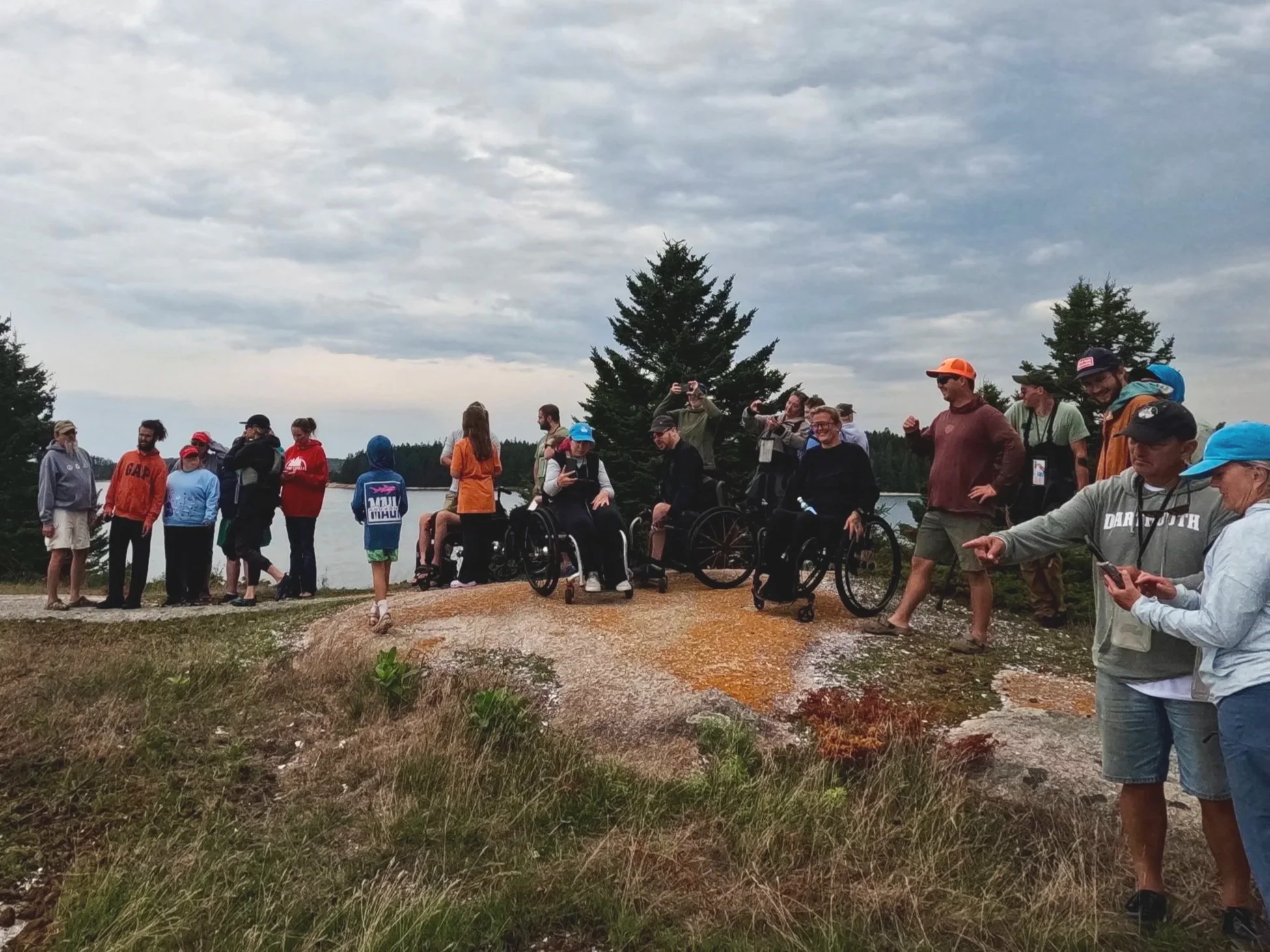 Volunteers assist adaptive paddlers to Little Camp Island