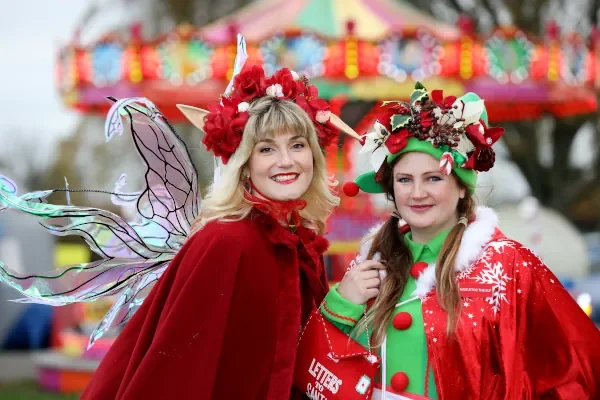 Women dressed in Christmas costumes.
