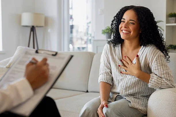 woman with hand over heart in therapy
