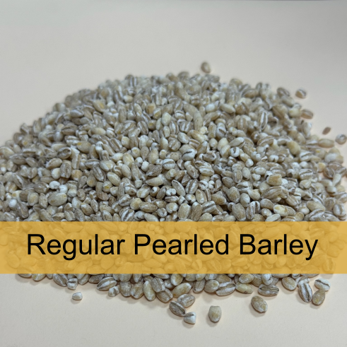 A pile of regular pearled barley grain on a white surface with a label reading 'Regular Pearled Barley'.