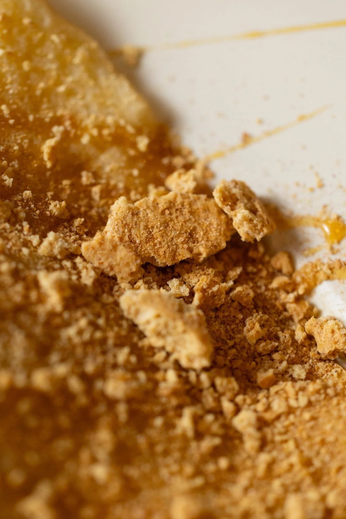 Close view of banana slices dusted with cinnamon crumble on whipped cream atop a crepe