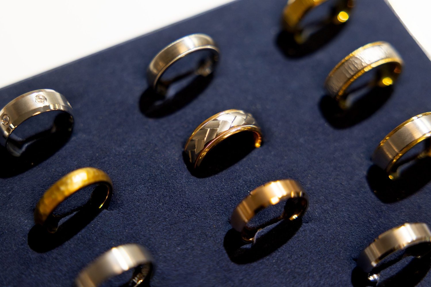 Rows of men's rings on a navy velvet tray at Farr's Jewelry in Logan, Utah