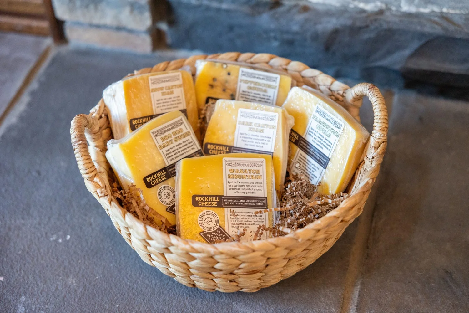 Basket of labeled cheese wedges from Rockhill Creamery in Richmond, Utah