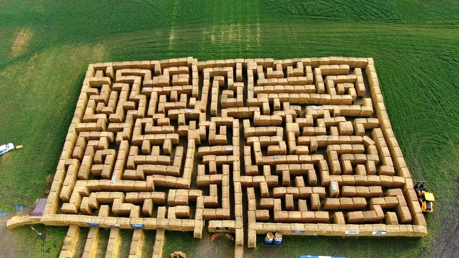 Aerial view of a hay bale maze laid out on a green field