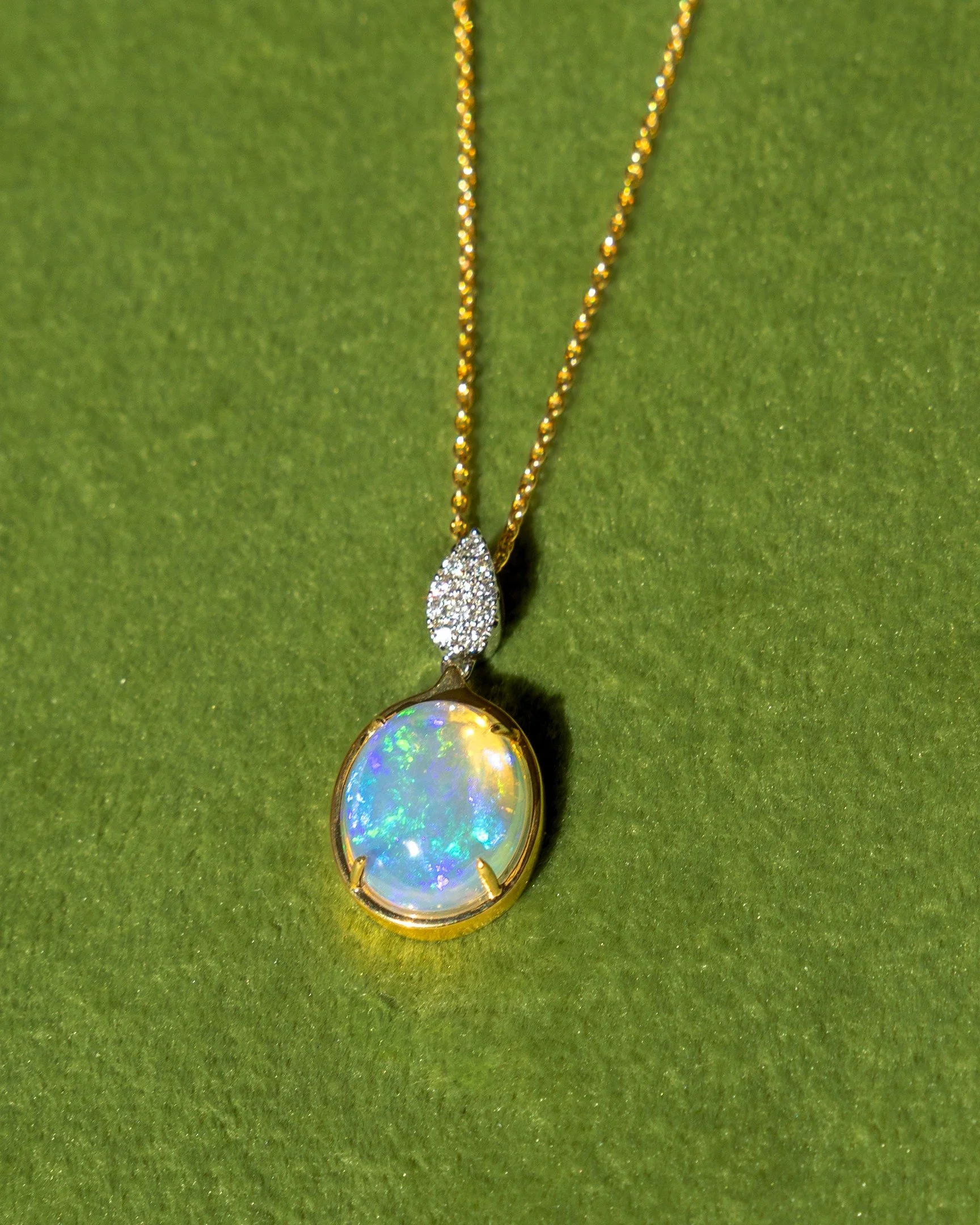 One opal, a simple green backdrop, and nothing else in the frame.

With jewelry, the background matters almost as much as the piece. A busy background competes with the details. A simple one lets the color and shape stand out.

After the close-ups, I