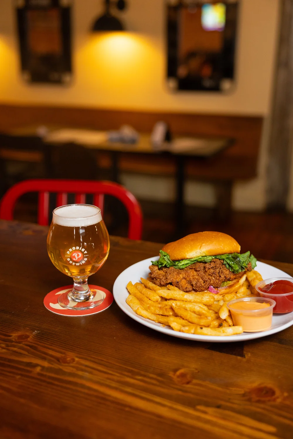 Beer and a burger on a table at Prodigy Brewing in Logan