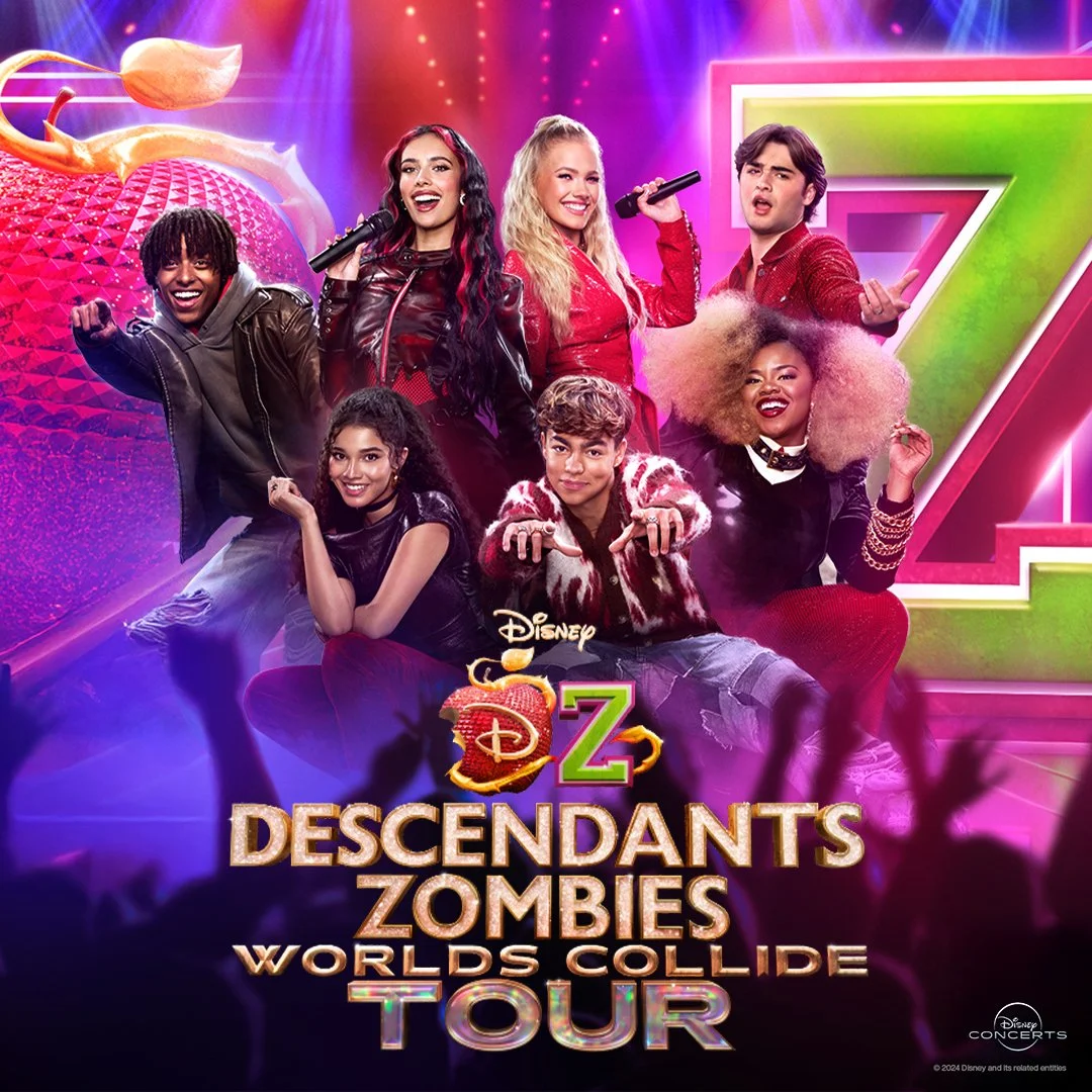 Group of seven diverse young performers on stage with colorful background, holding microphones, promoting Disney Descendants Zombies World Collide Tour.