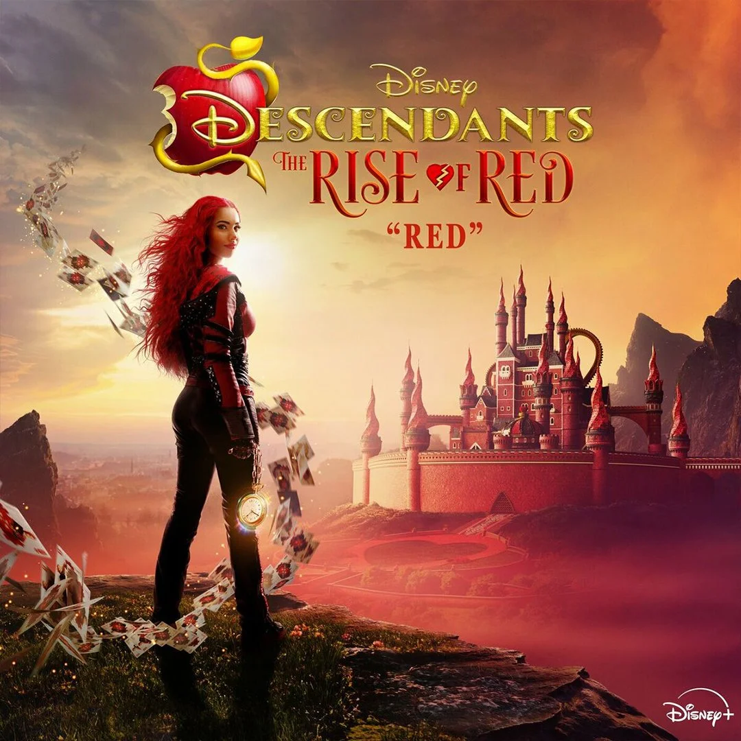 Promotional poster for Disney's 'Descendants: The Rise of Red.' A woman with long red hair stands on a grassy hill with a castle in the background. She wears a black and red outfit and holds a pocket watch, with playing cards swirling around her. The