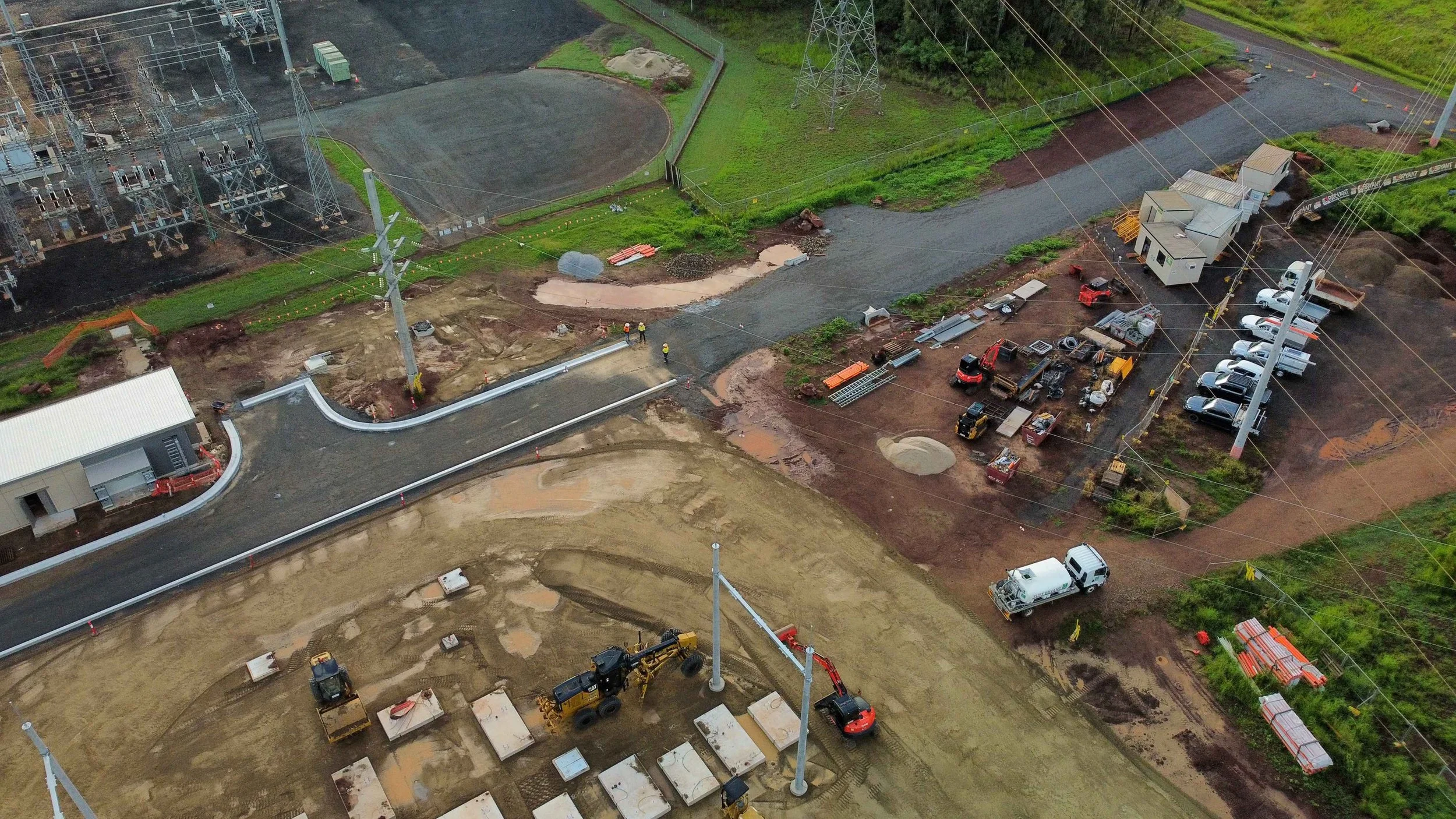 Aerial view of civil construction works at TUWE Turkinje West Substation in Mareeba, showing site preparation, concrete foundations, heavy machinery, access roads and surrounding electrical infrastructure.
