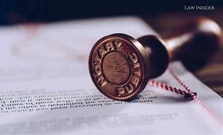 Notary public stamp pressed onto legal documents, symbolizing certified notarization services.