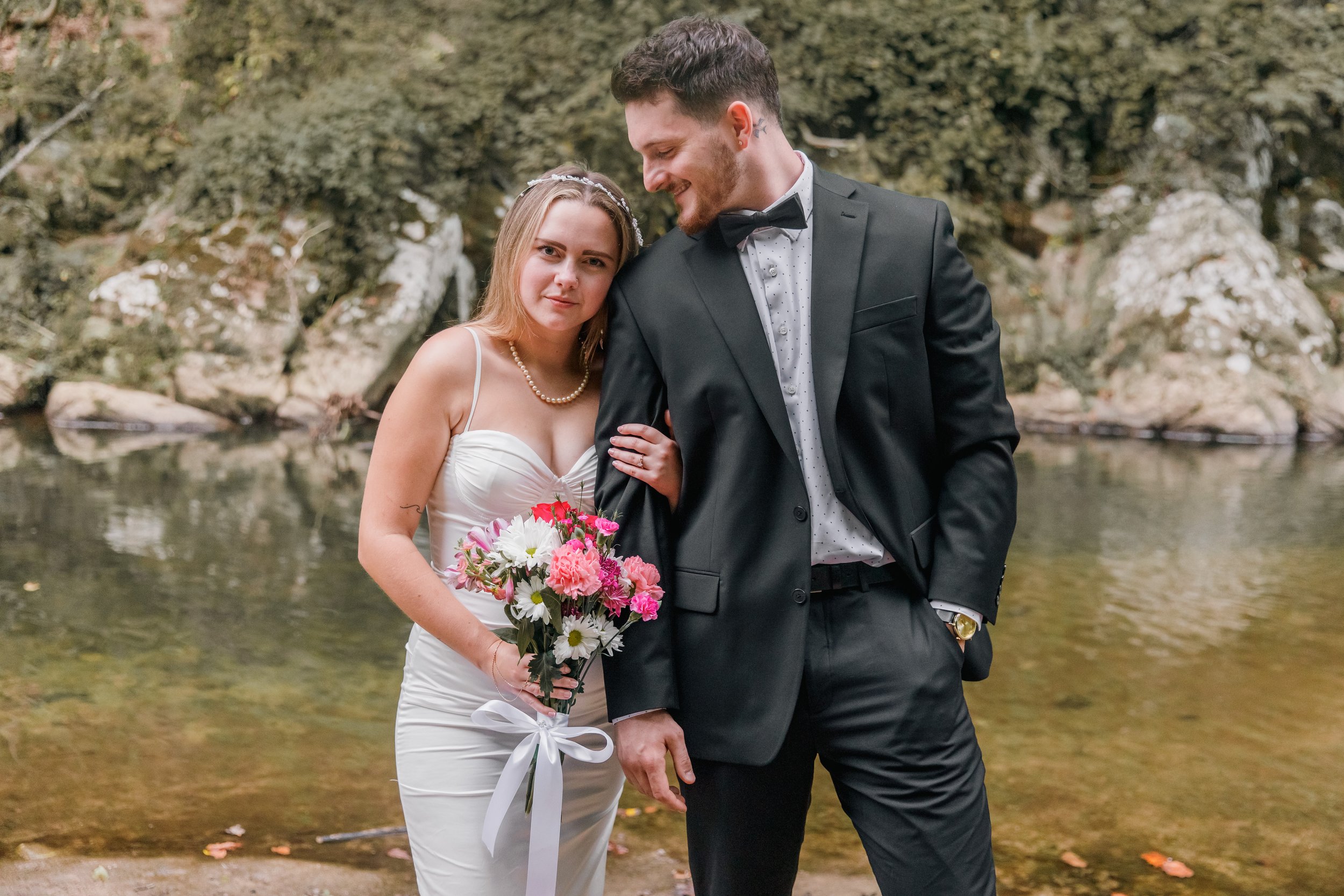 A bride leaning on the groom during their fall elopement in Rocks Creek Park in Washington DC.