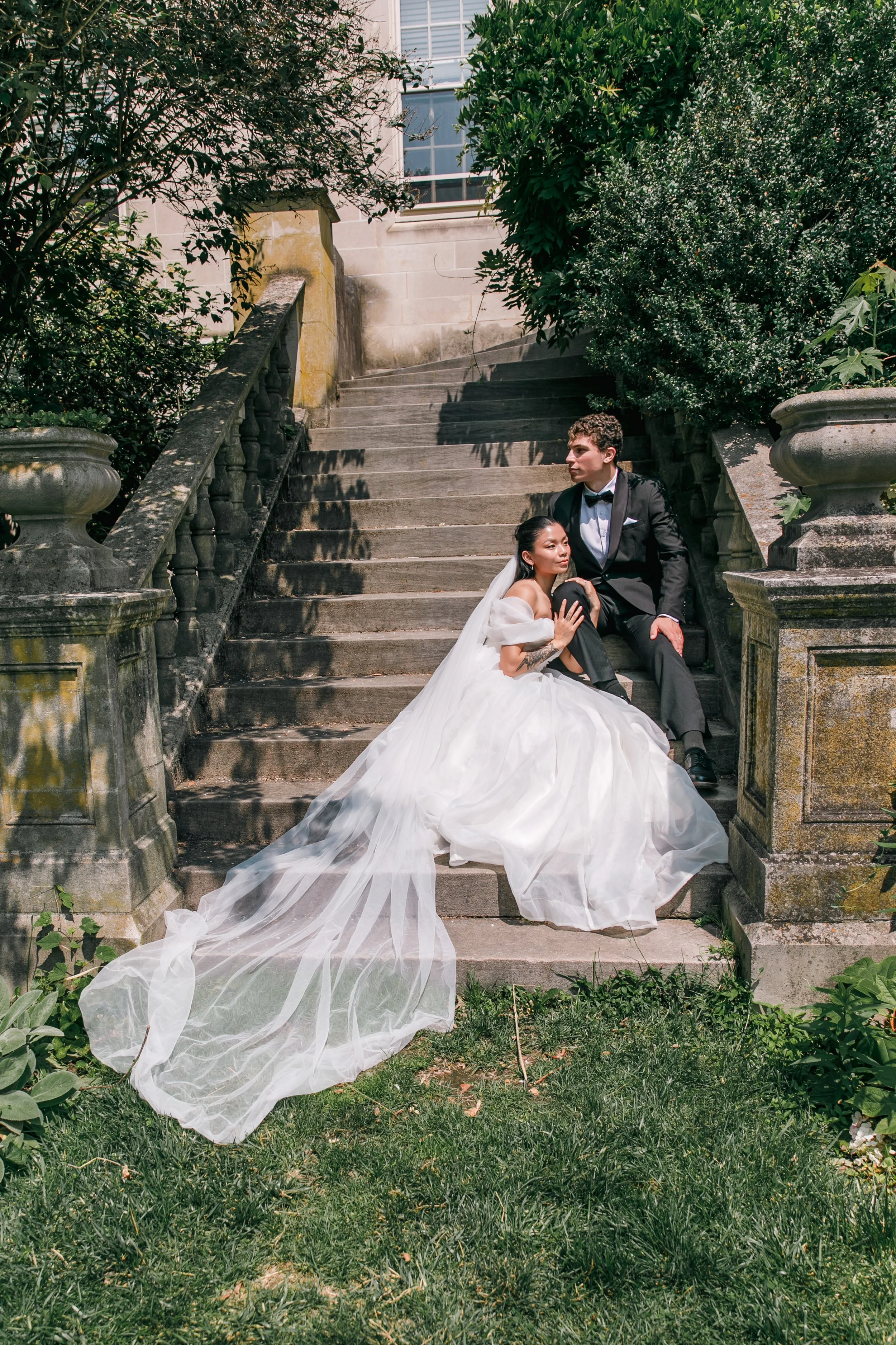 An editorial bride and groom on the steps during their elopement at Bishop's Garden in Washington DC.