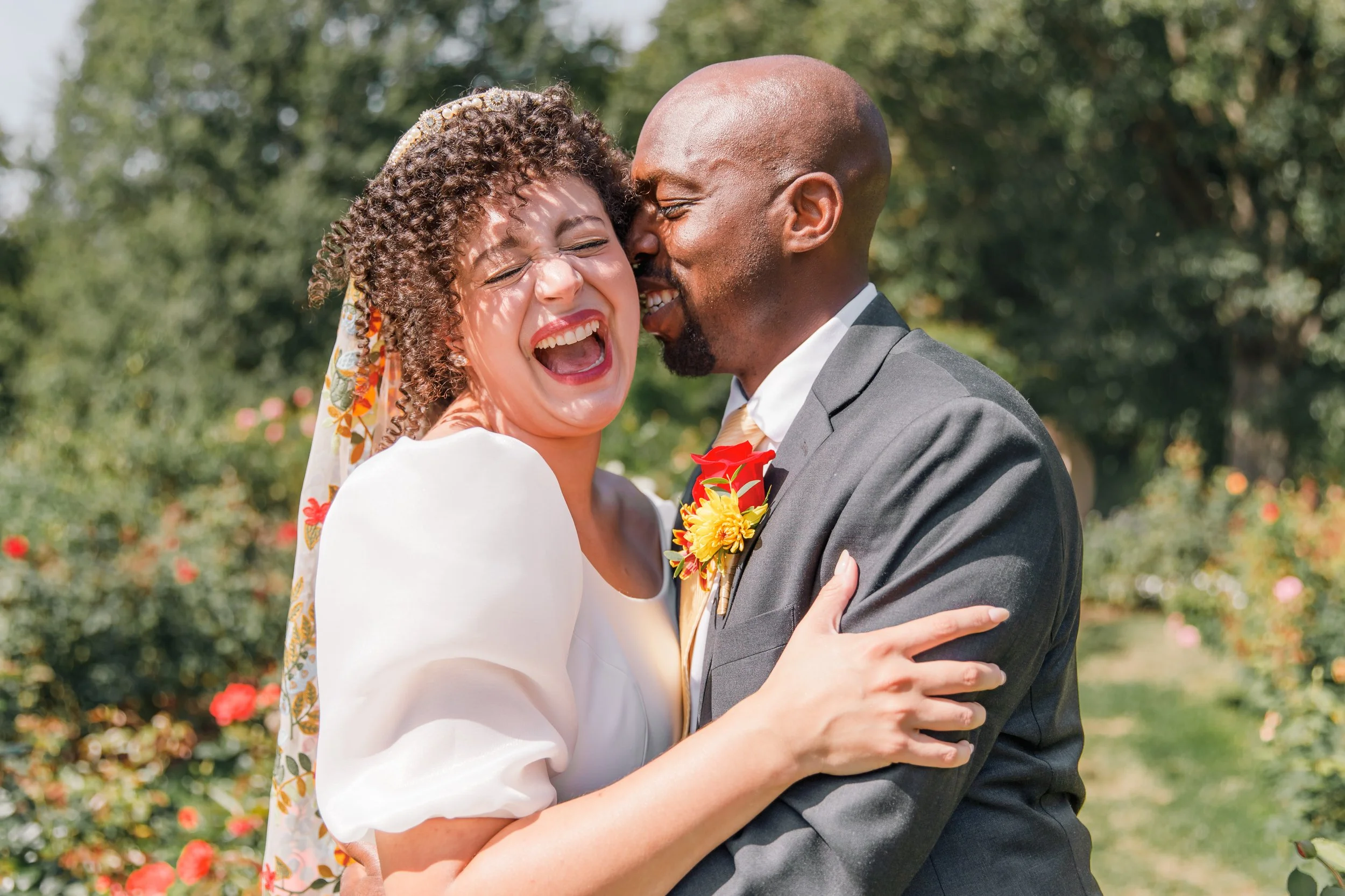 A couple laughing together before their elopement in Bon Air Rose Garden in Arlington, Virginia.