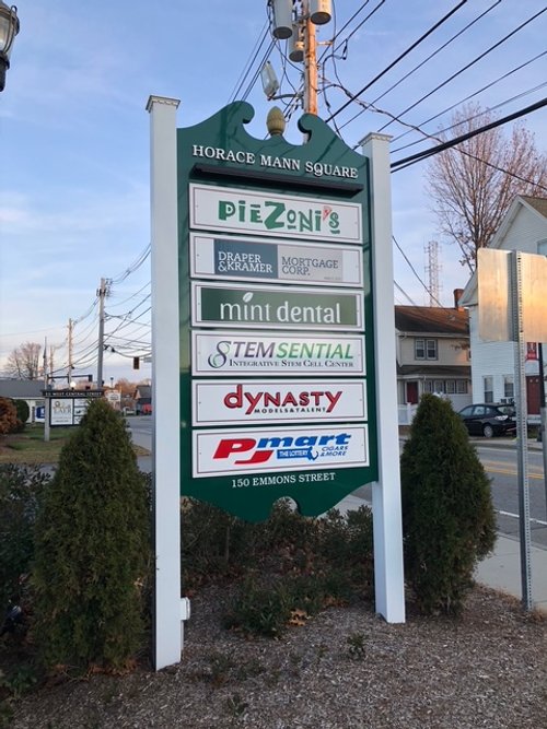 Signboard for Horace Mann Square listing various businesses including Piezoni's, Draper & Kramer Mortgage, Mint Dental, STEM Sential, Dynasty, and Pmart, located at 150 Emmons Street.