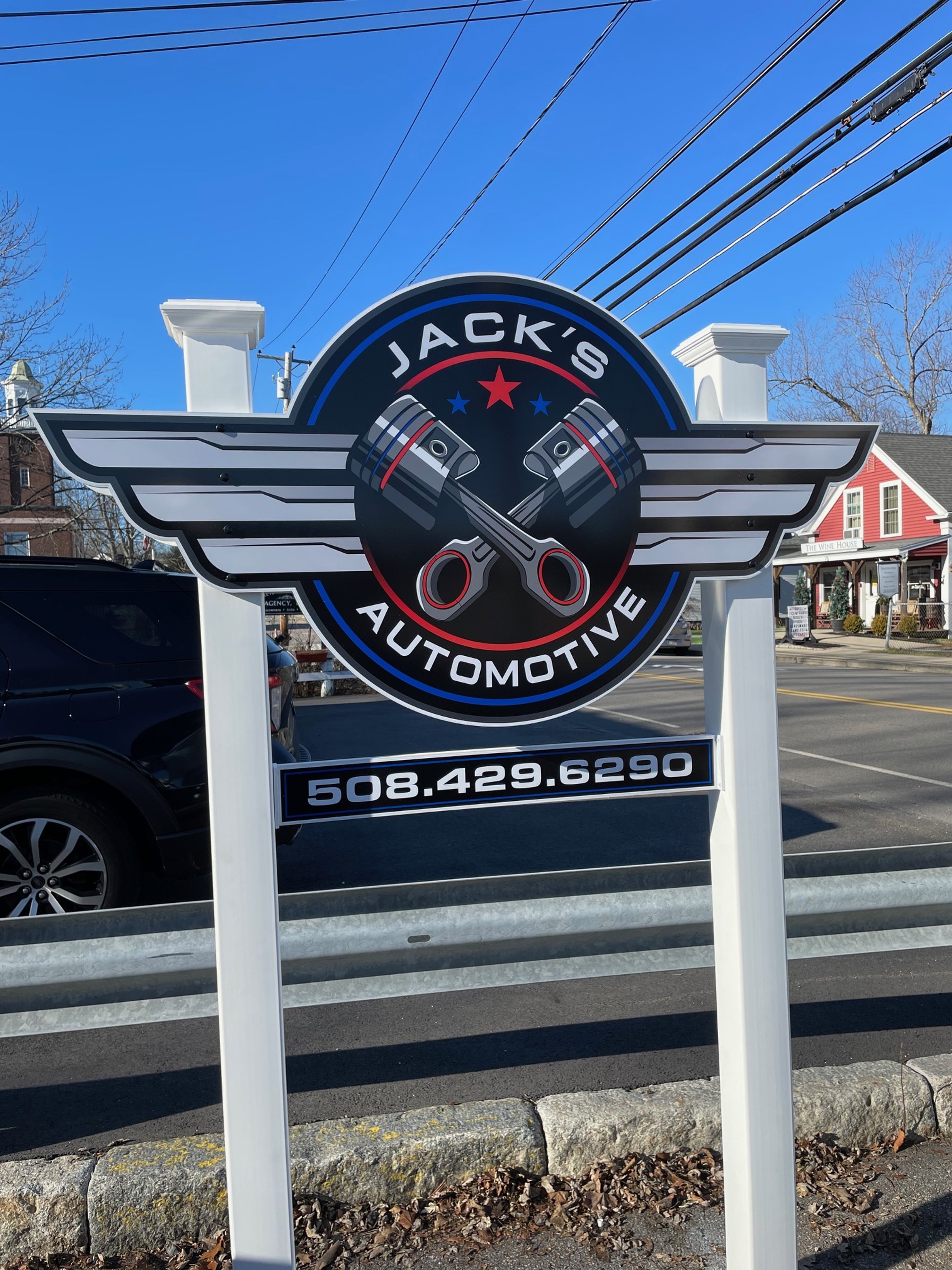 Freestanding large for Jack's Automotive featuring crossed pistons, wings, and the phone number.