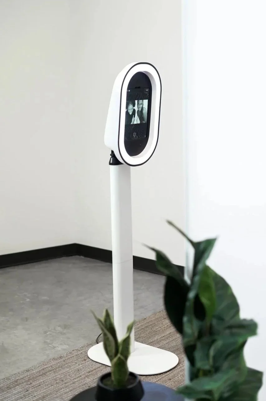 Sleek modern photo booth with built-in ring light and digital display, perfect for events and celebrations.
