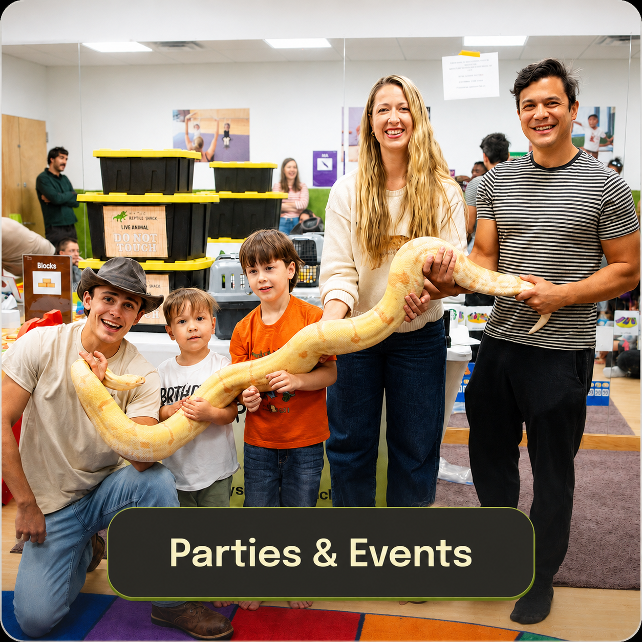 Group of people at a party holding a large yellow a snake, with children and adults smiling, in a room decorated with colorful banners and animal-themed signs, under the caption "Parties & Events."