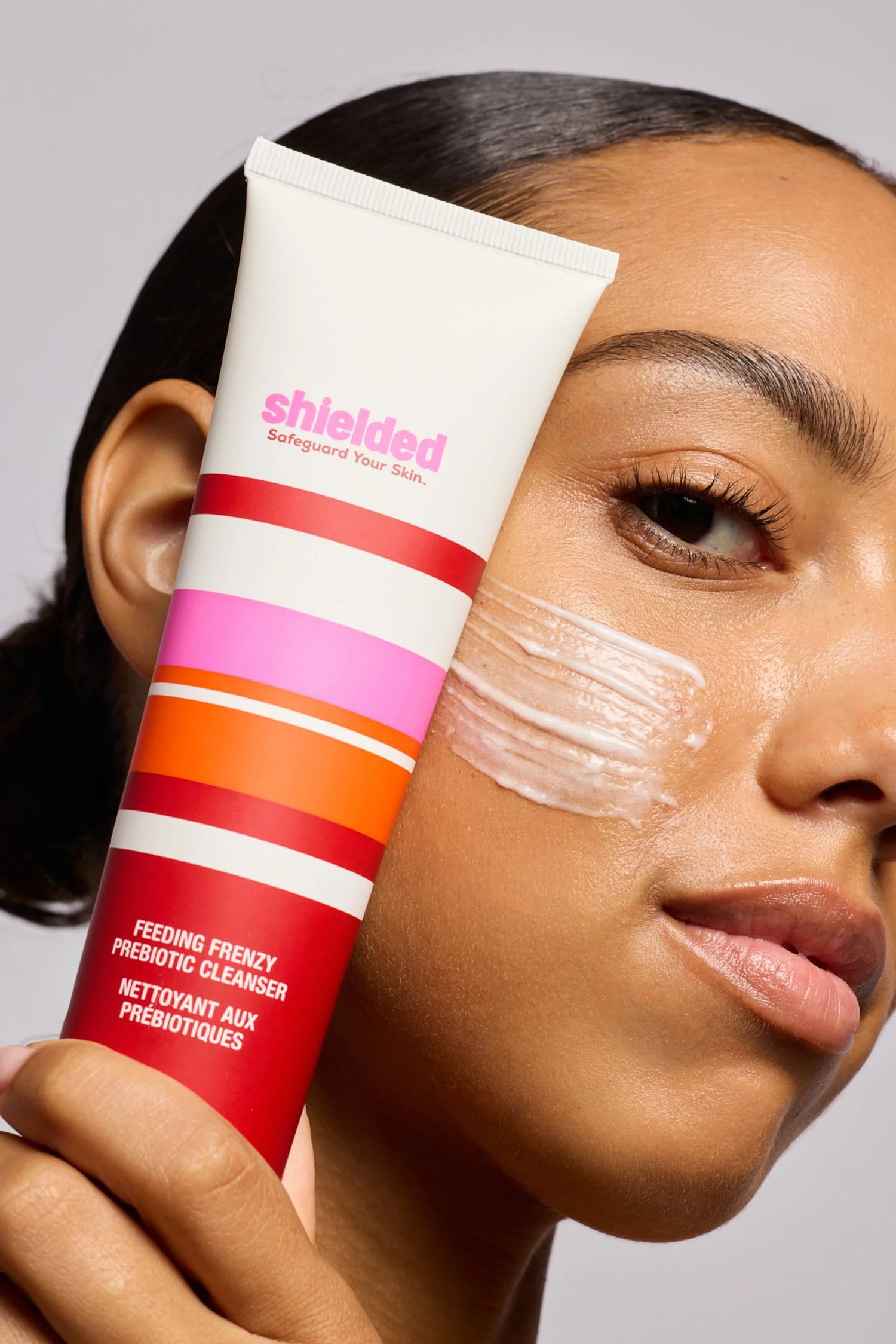 Female model applying cleanser with skincare branding visible — Los Angeles shoot