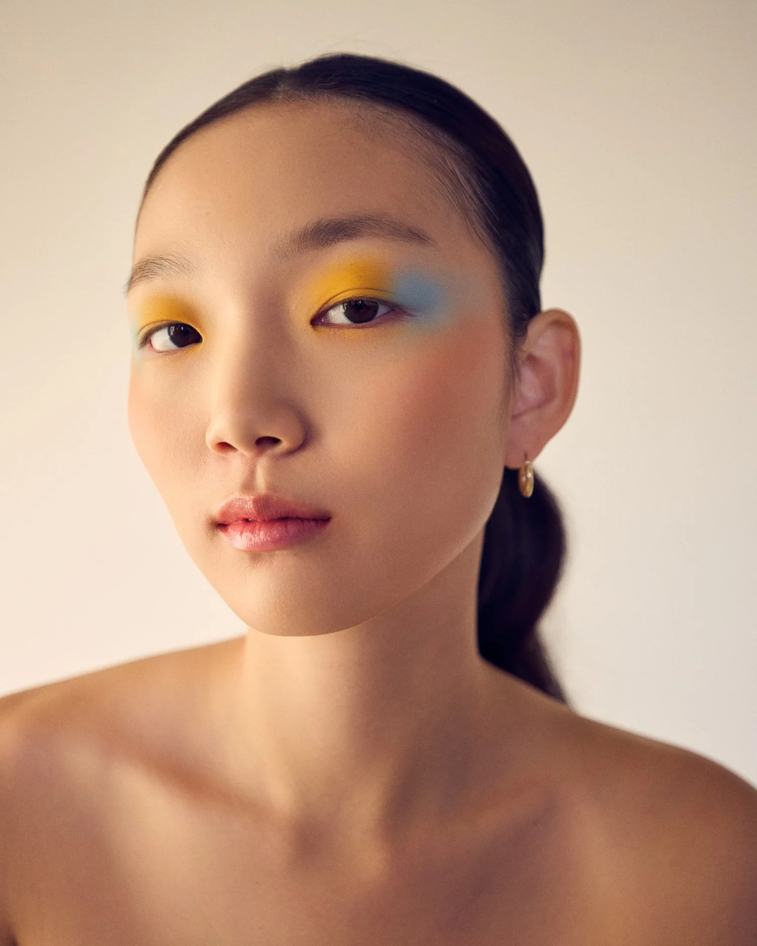 Beauty editorial with vibrant yellow eyeshadow for a high-fashion beauty shoot.