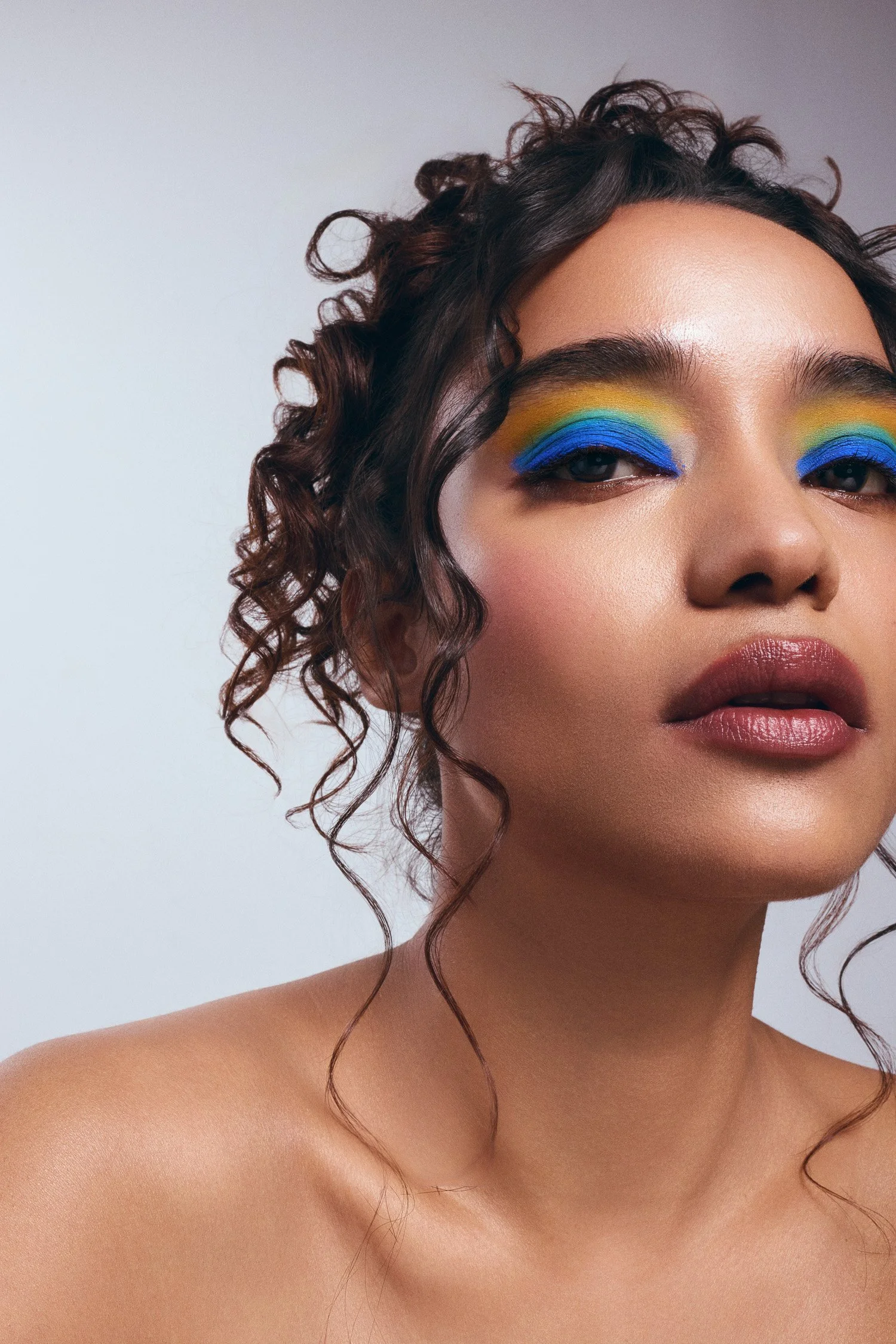 Bold editorial eye look with blue and yellow eyeshadow — beauty campaign shoot in LA