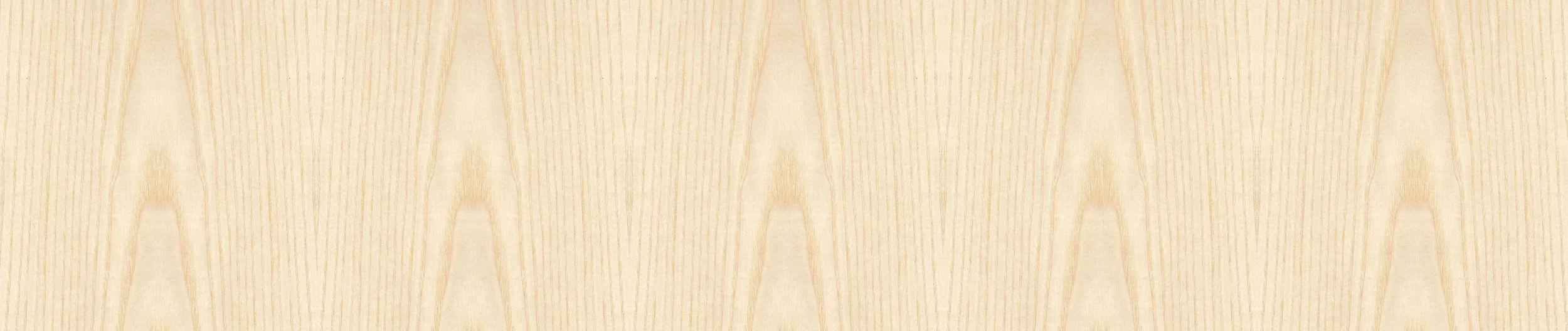 Close-up of a light-colored wooden surface with a chevron pattern.