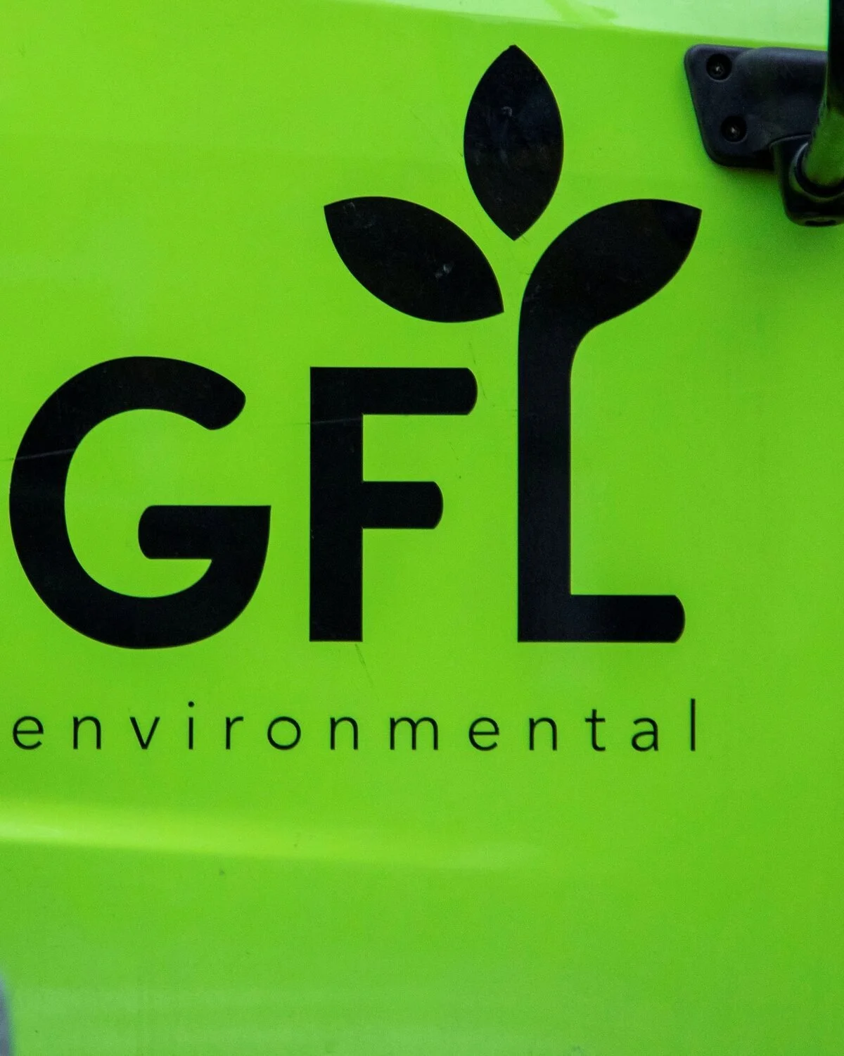 Green background with a black logo featuring the letters GFL and a plant sprout on top, with the word 'environmental' written below.