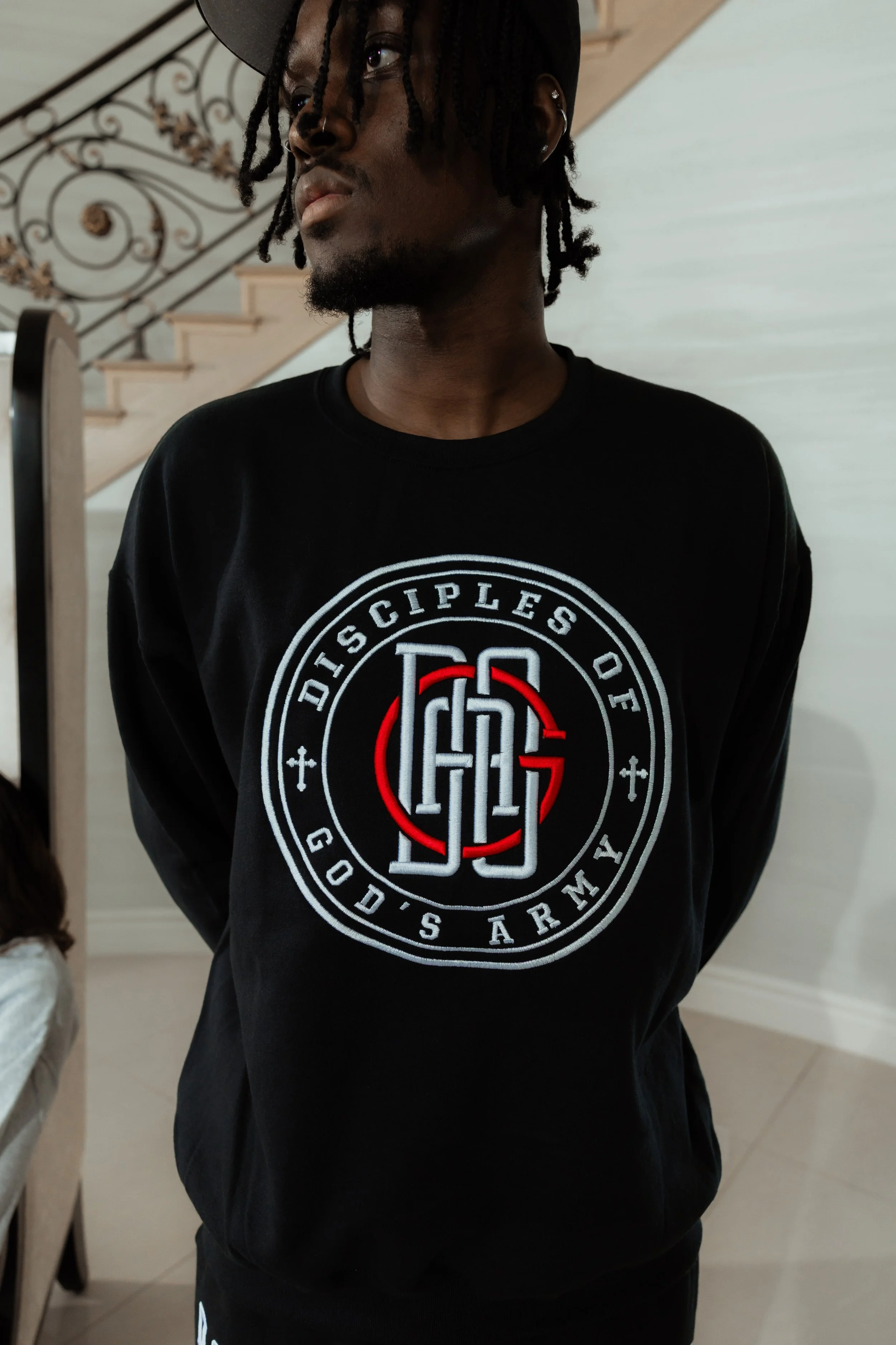 A black Disciples of God's Army crewneck sweatshirt with a white and red embroidered logo that reads 'Disciples of God’s Army'.