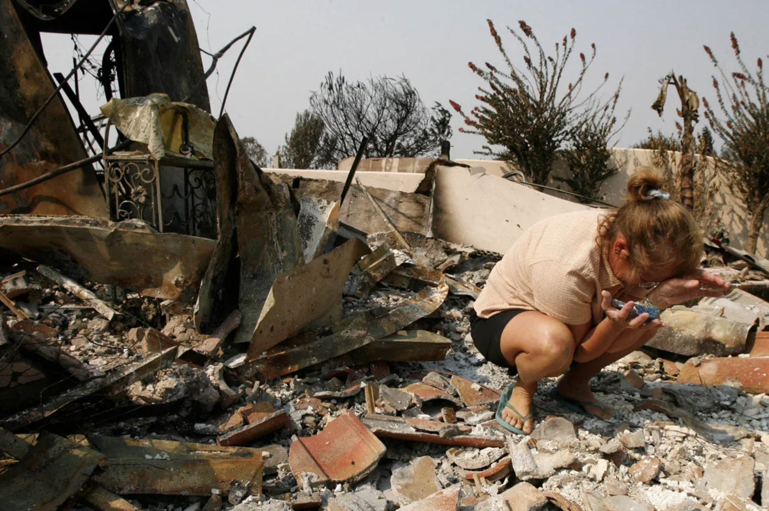 Woman weeps in ruins after disaster