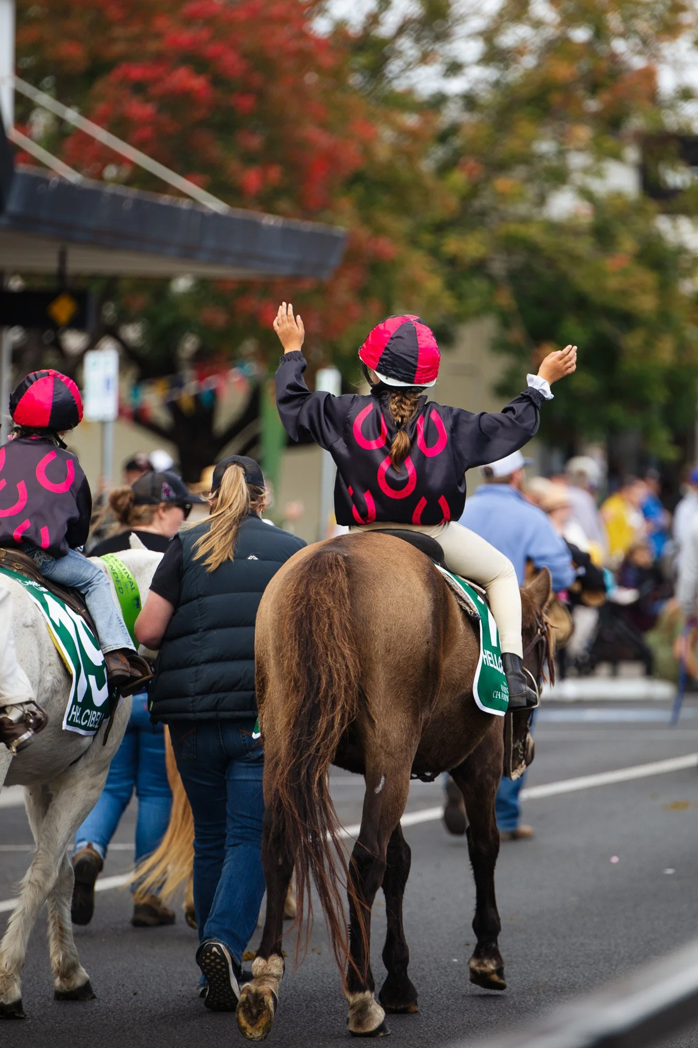 Young girl dressed as jockey in Scone horse festival street parade