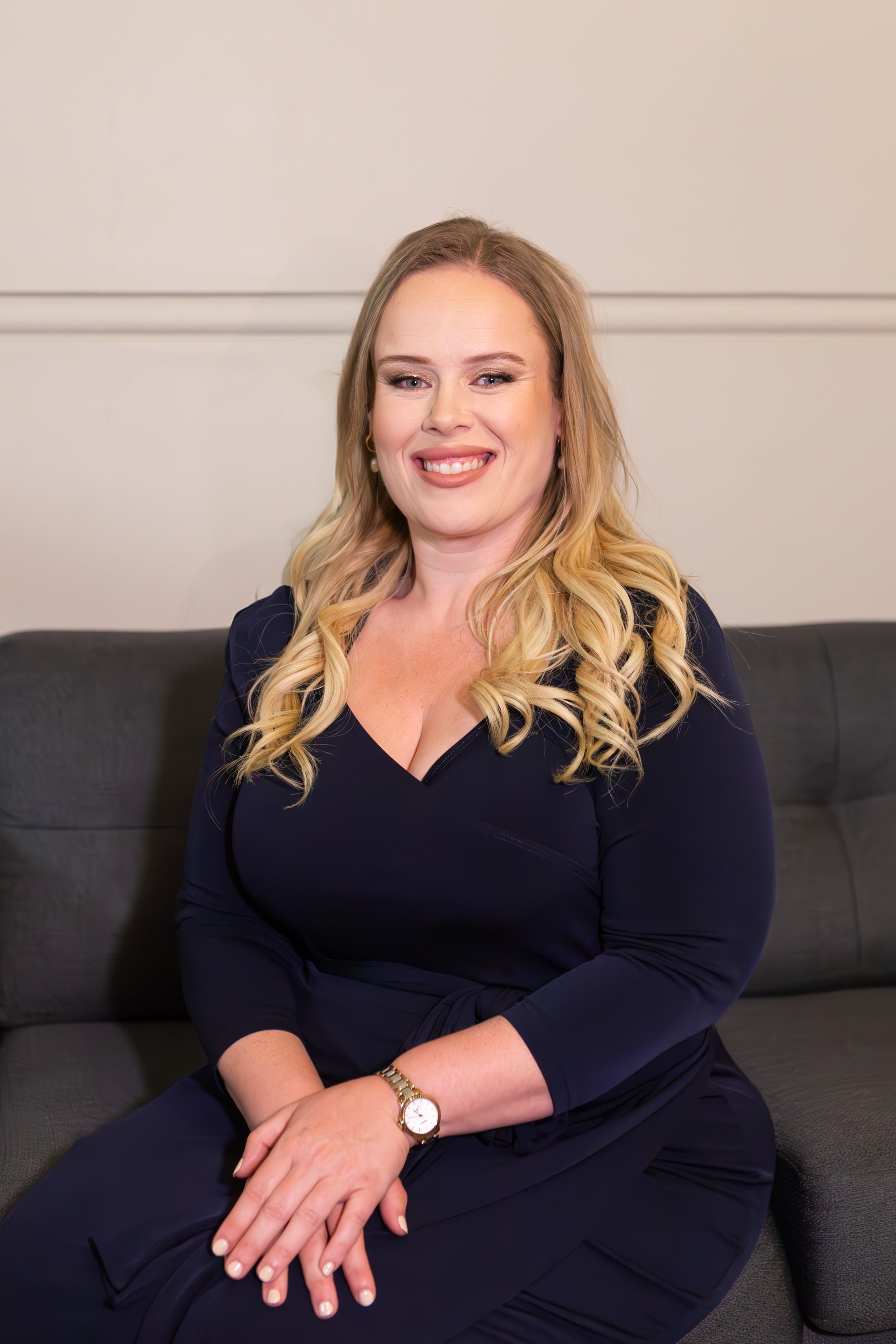 woman smiling holding hands sitting on lounge