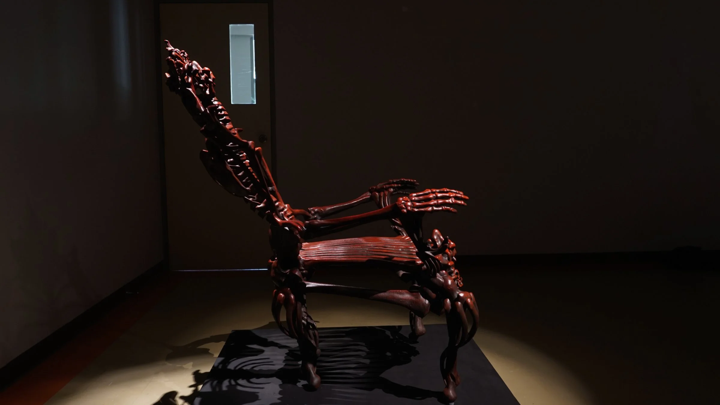 Side view of Bloody Chair by Ratthakorn Disjaiyen - Red hand-painted acrylic on fiberglass resin